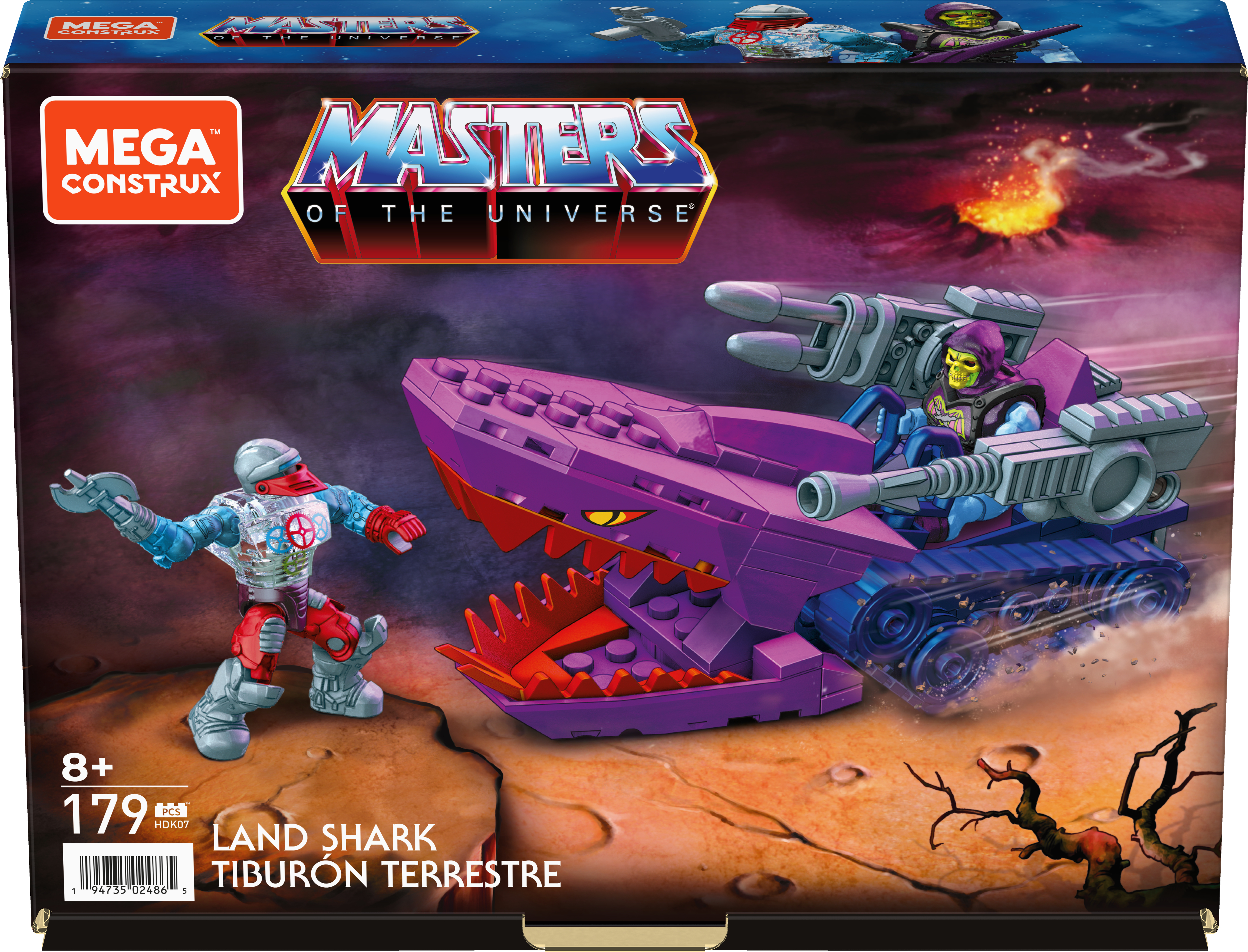 Scatola giocattolo Land Shark di Masters of the Universe con figure e veicolo in un paesaggio desertico.