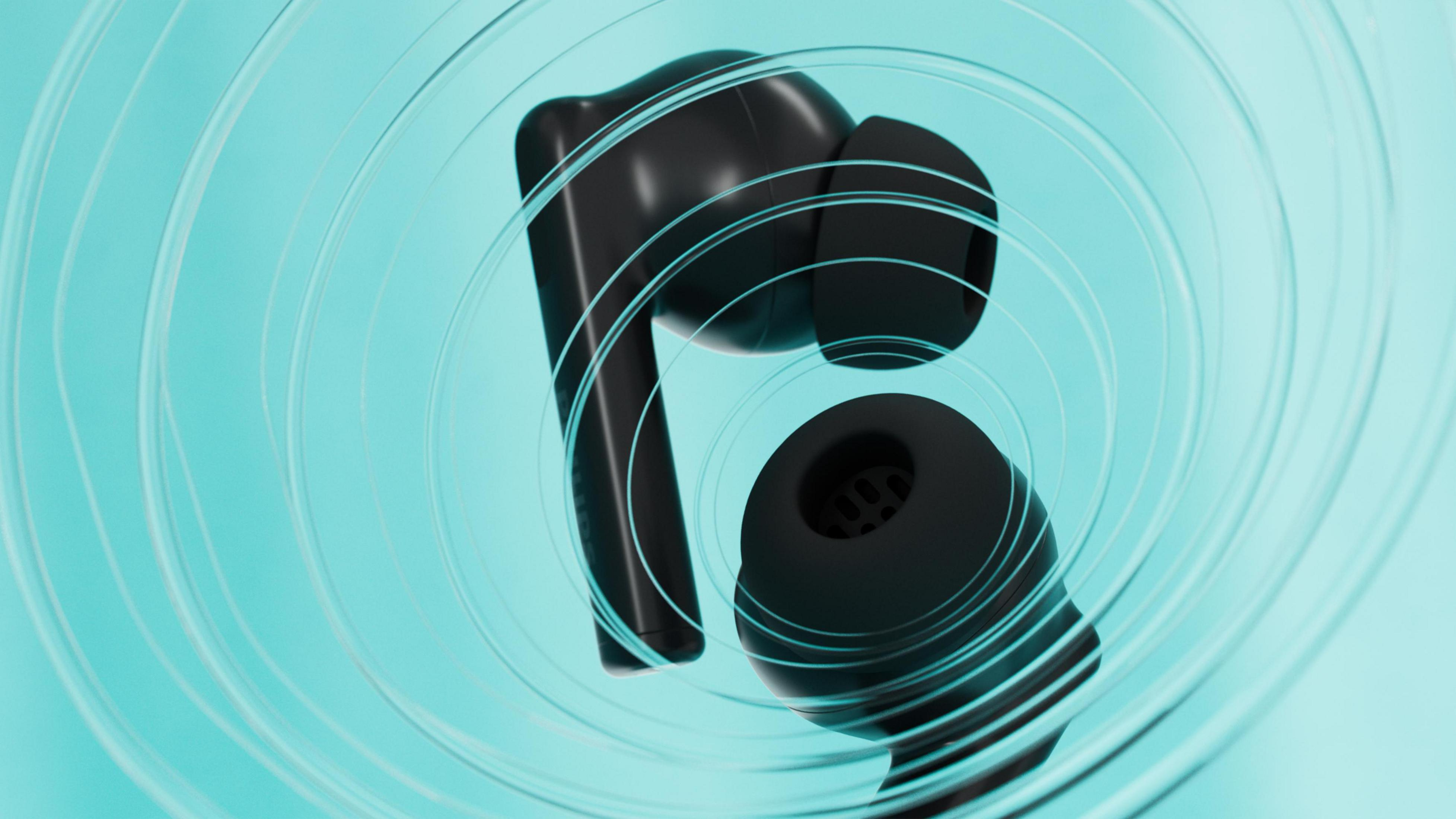 Auriculares negros con anillos transparentes sobre fondo turquesa.