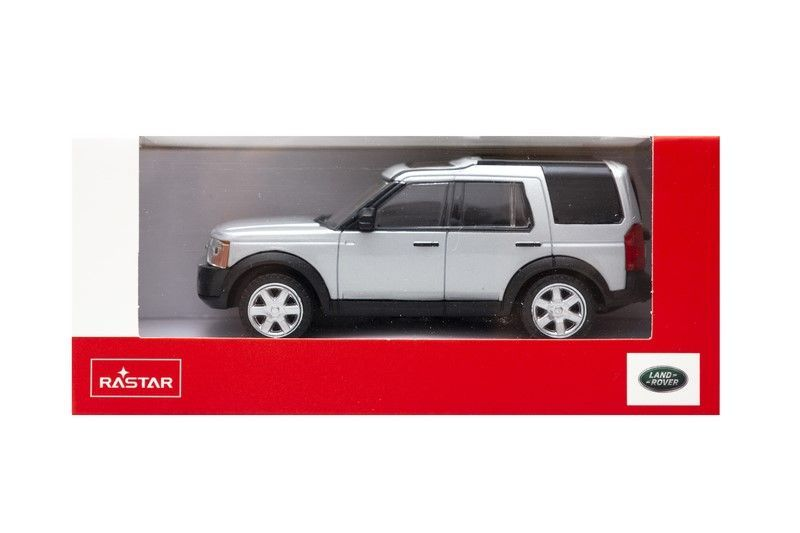 Srebrny samochód zabawka Land Rover w czerwonym pudełku z logo.