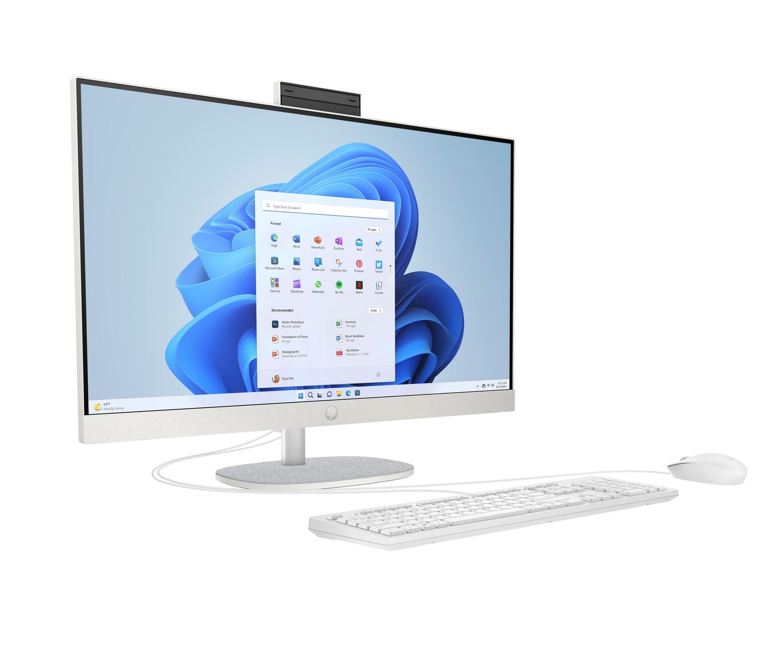 Ein weißer All-in-One-PC mit Tastatur und Maus, der auf einem Schreibtisch steht.