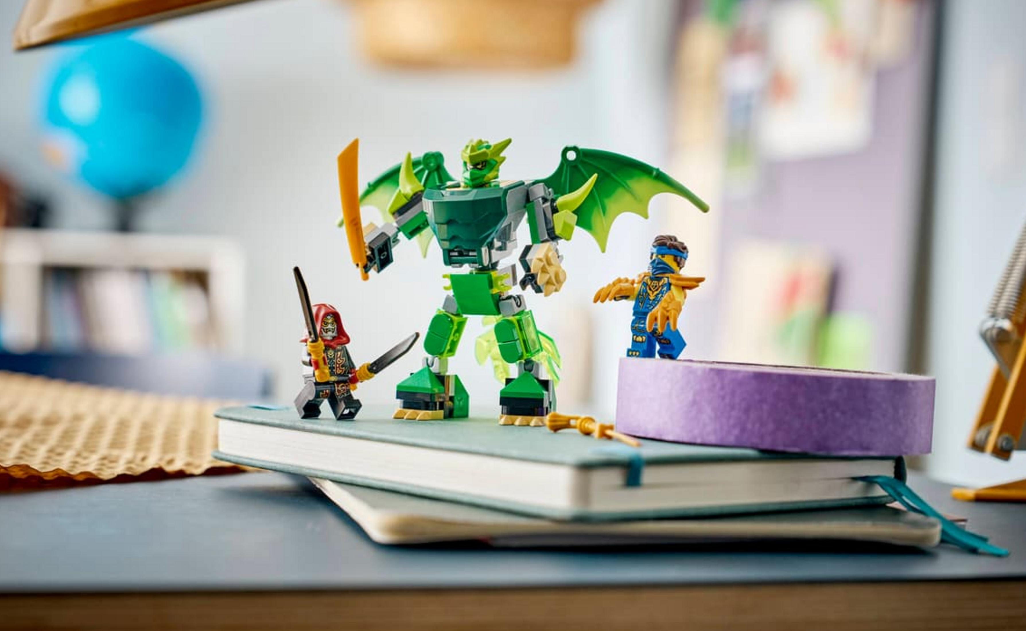 Robot dragón verde con dos ninjas sobre libros. Un globo azul al fondo.