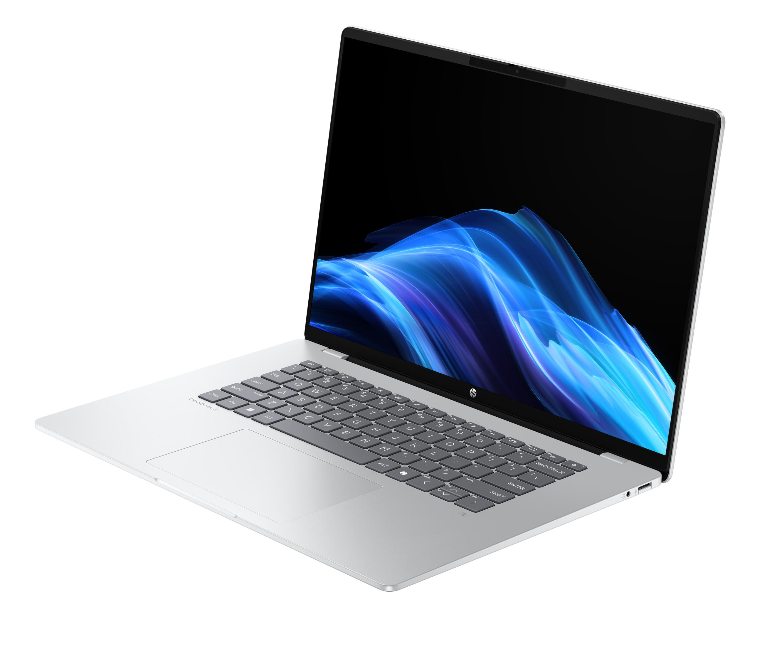 Ein silberner Laptop mit blauem, wellenförmigem Hintergrund auf dem Bildschirm.