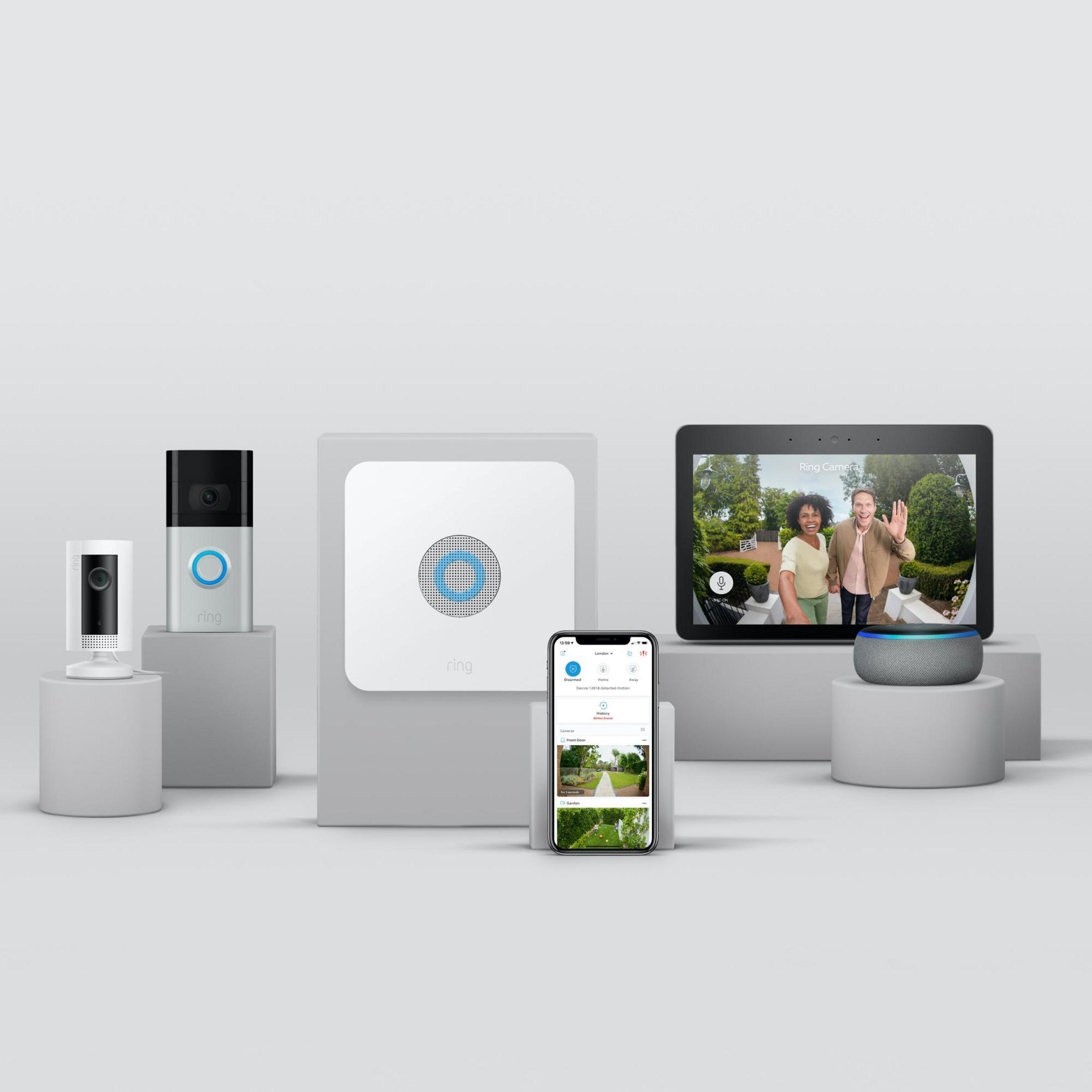 Dispositivos Ring: cámaras, una tableta y un altavoz inteligente en pedestales.