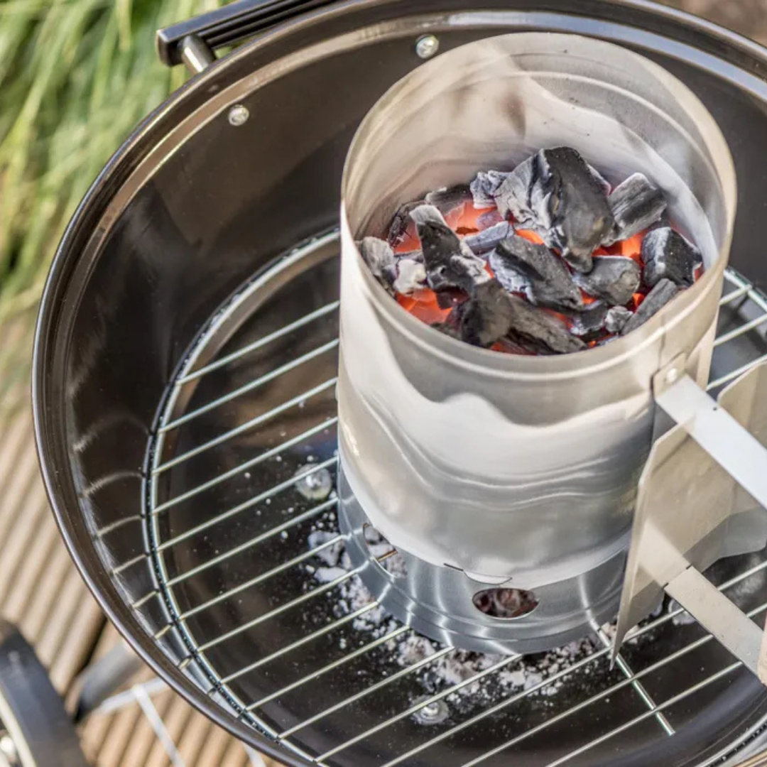 Glühende Holzkohle in einem Anzündkamin auf einem Grill.
