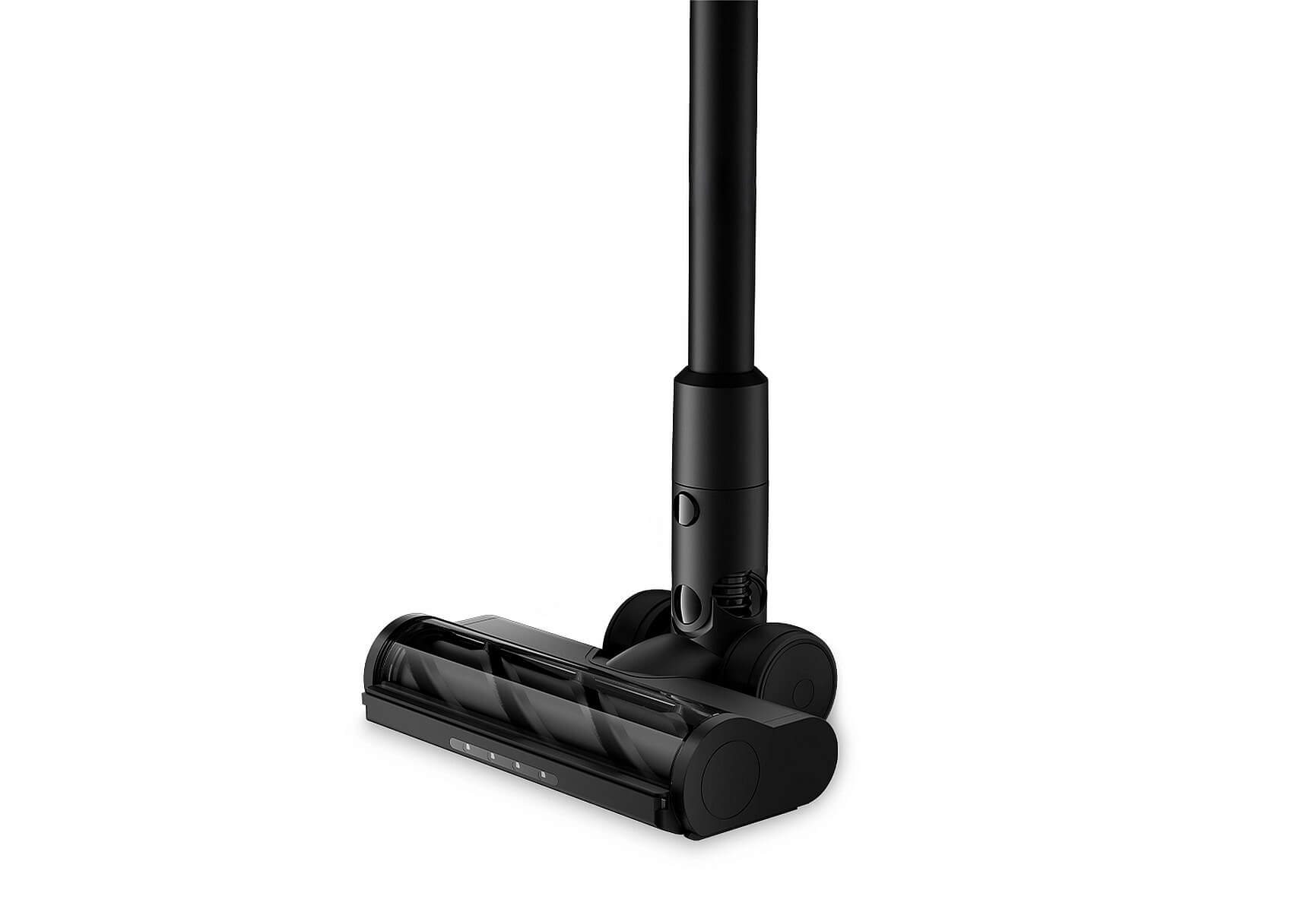 Tête d'aspirateur noire avec rouleaux et manche, sur fond blanc.