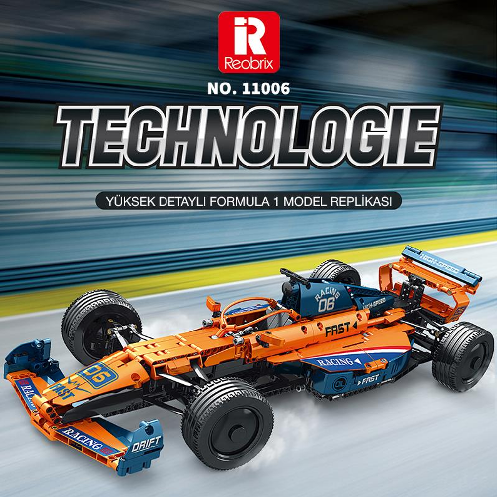 Turuncu ve mavi Formula 1 oyuncak yarış arabası pistte.