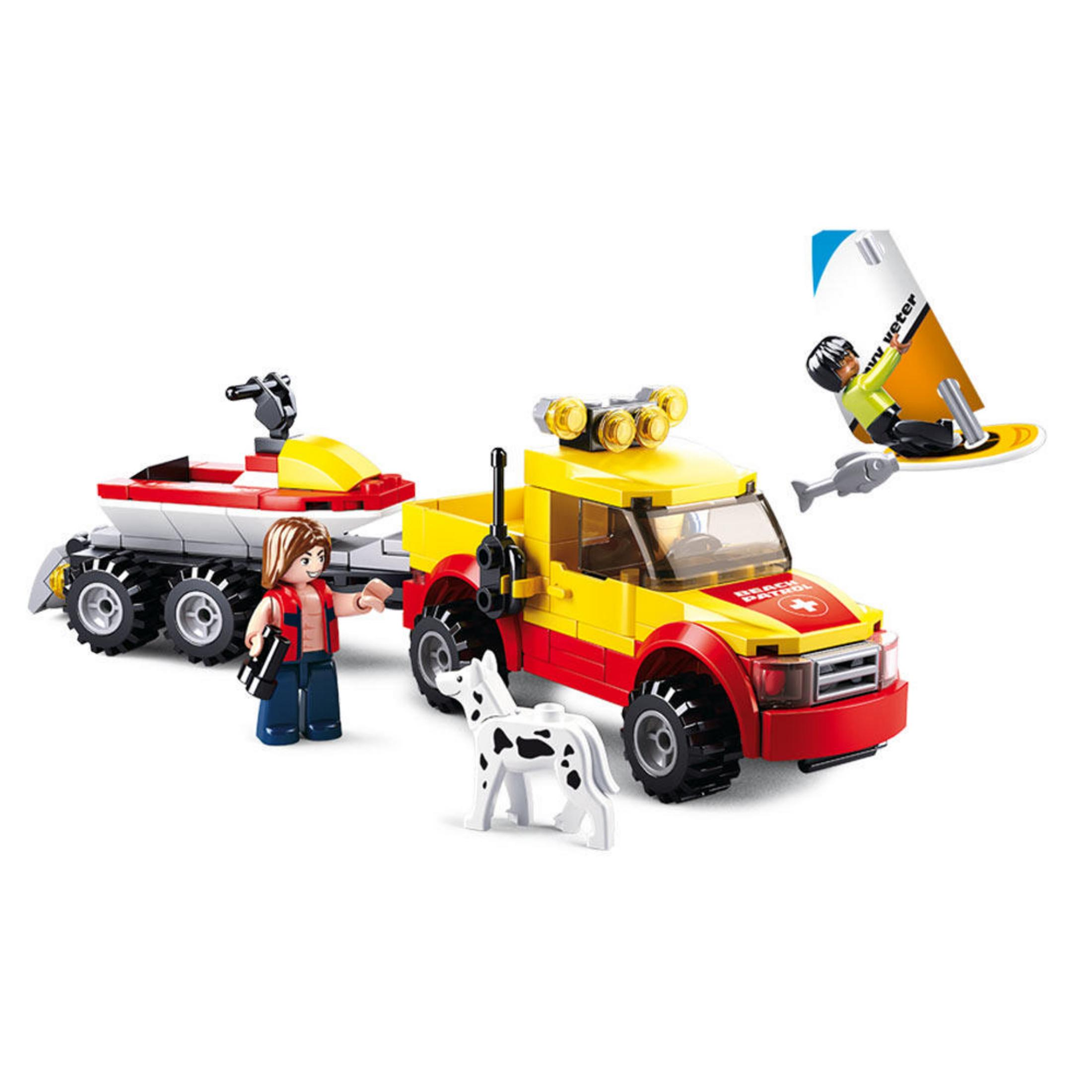 Ein Spielzeug-Rettungswagen mit Anhänger, Figur, Hund und Surfer.