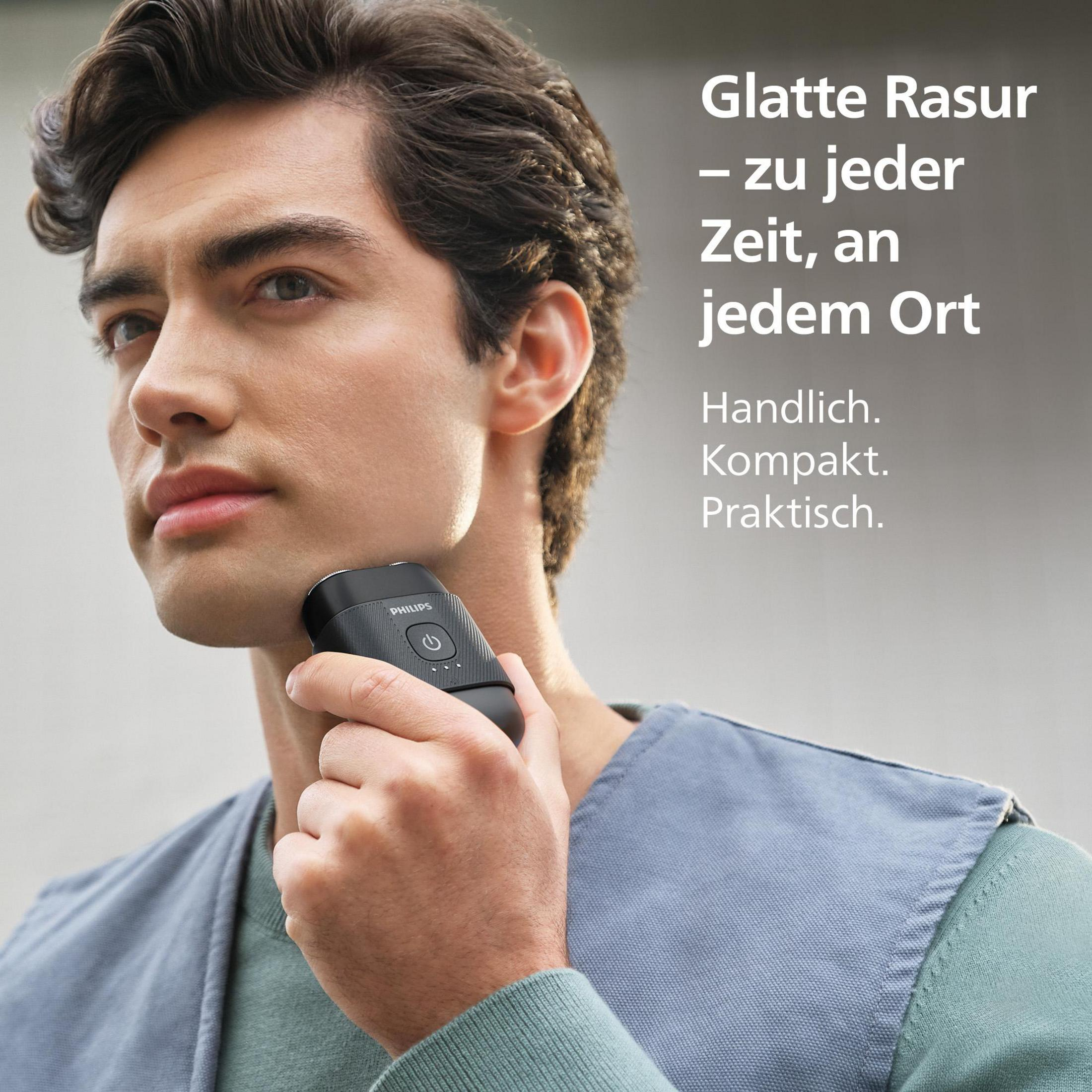 Ein Mann rasiert sich mit einem schwarzen Philips Rasierer am Hals.