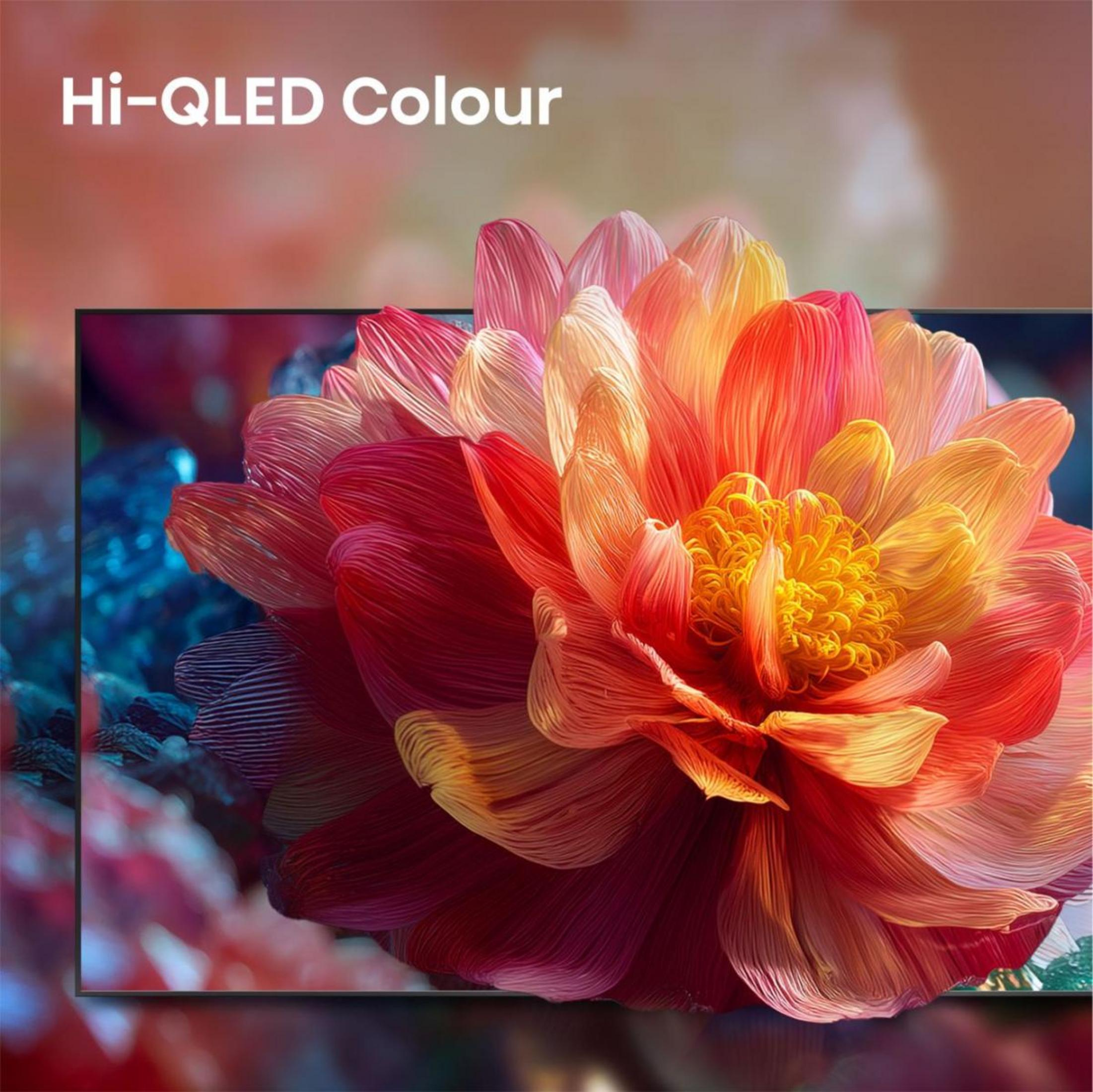 Nahaufnahme einer leuchtenden Blume mit roten, orangen und gelben Blütenblättern auf einem dunklen Hintergrund.