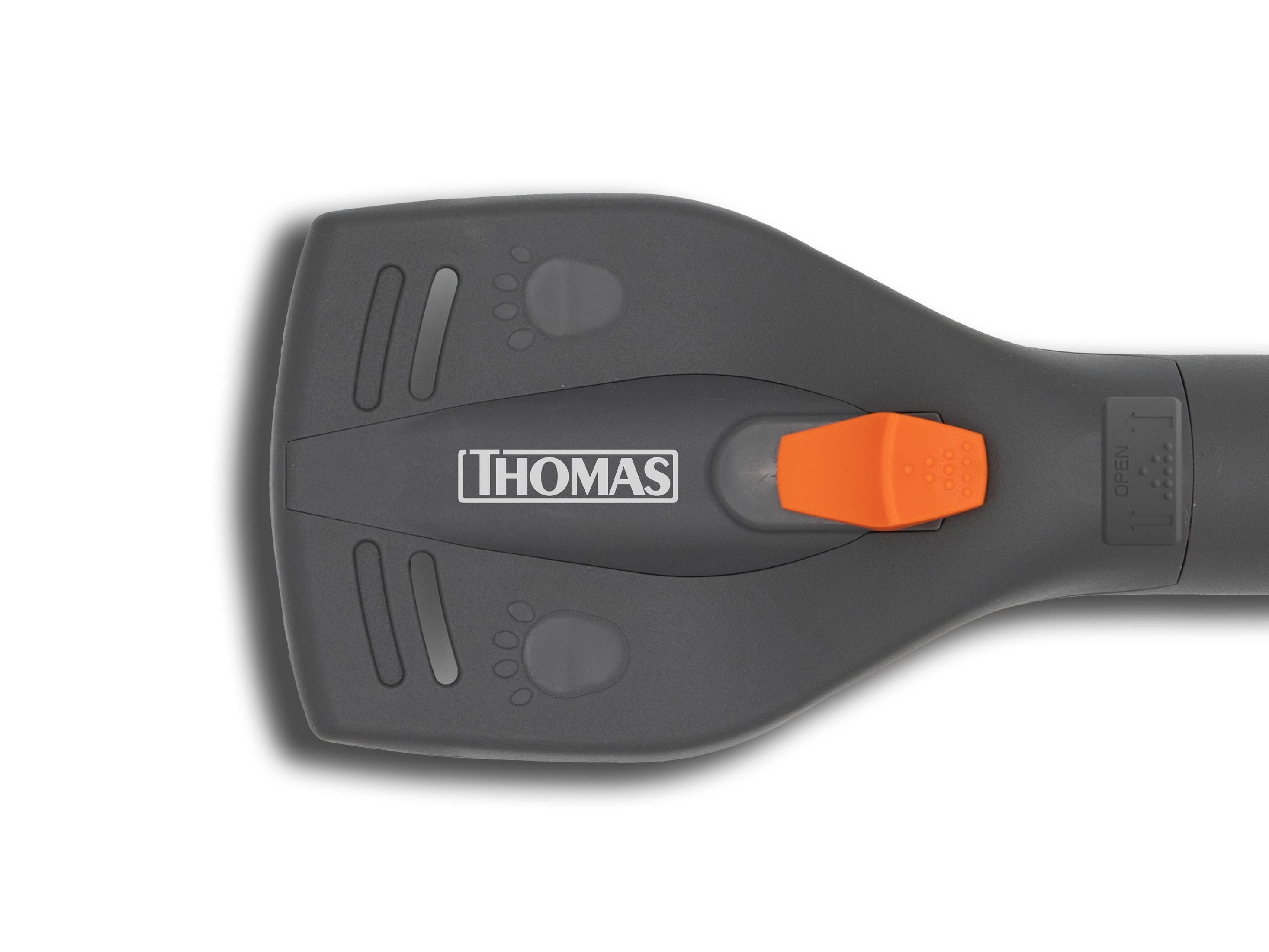 Grauer Handgriff mit oranger Taste und THOMAS-Logo. Mit Pfotenabdrücken.