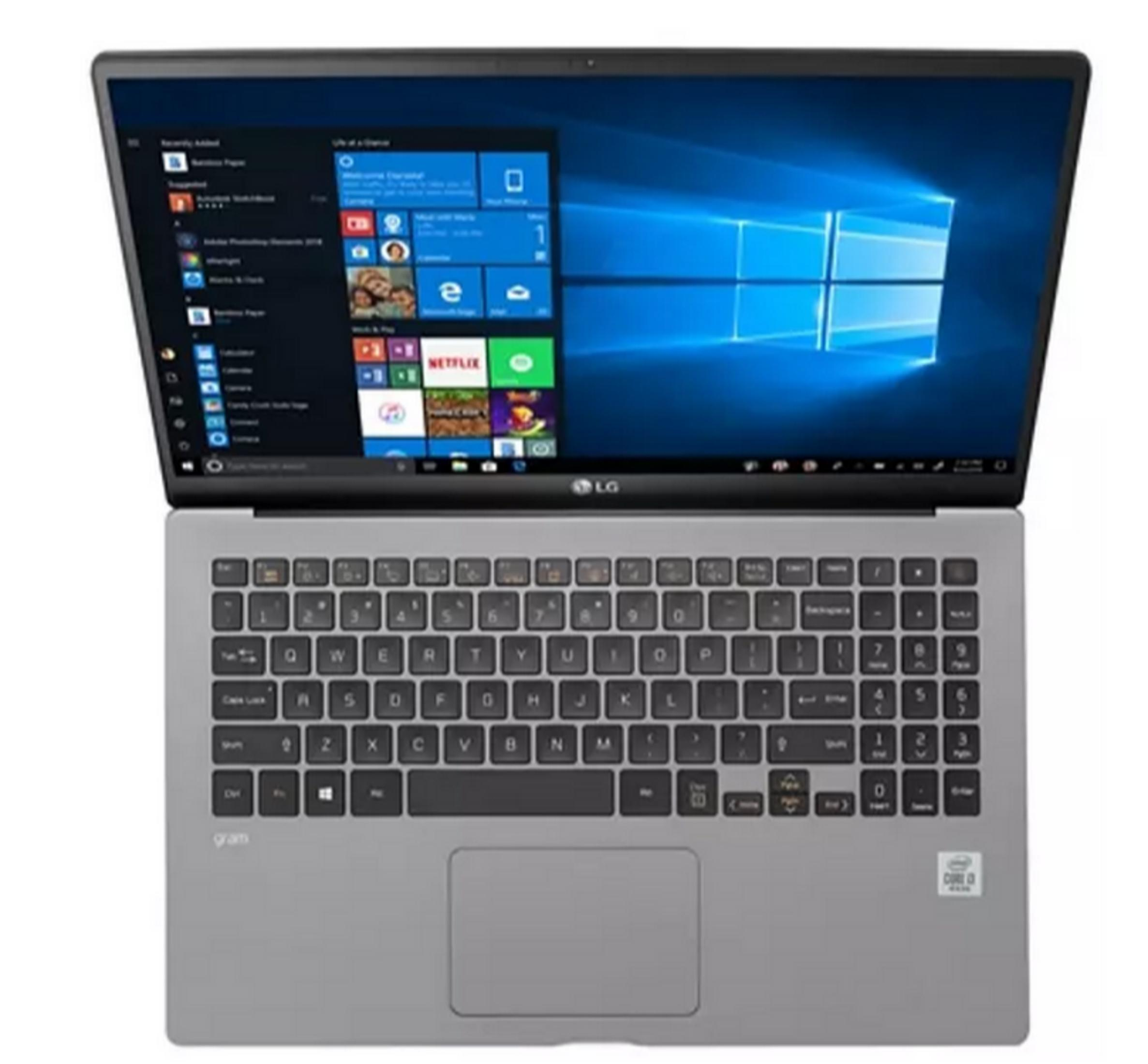 Un portátil LG Gram gris con la pantalla abierta, mostrando el escritorio de Windows.