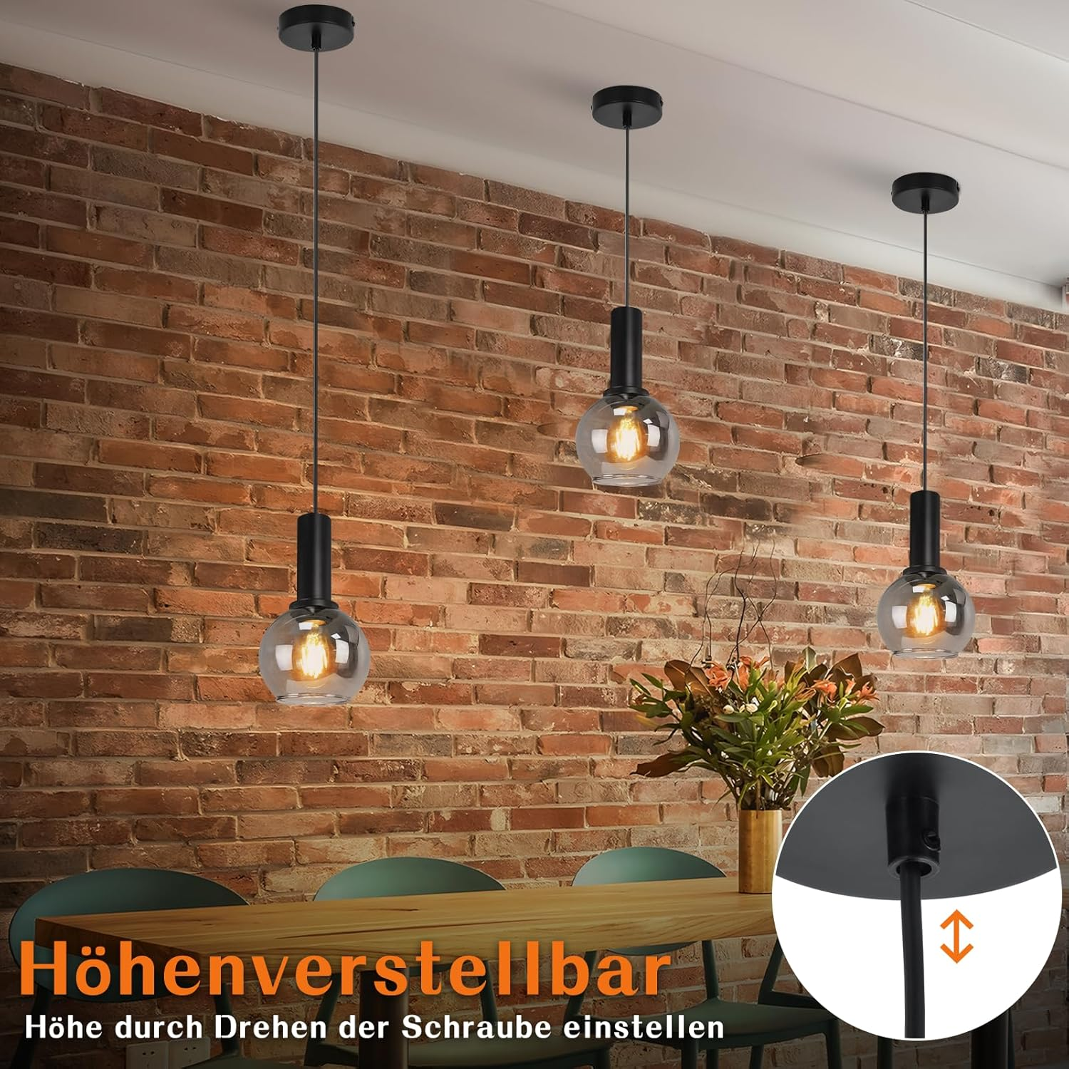Drei Pendelleuchten mit Glaskugeln hängen über einem Holztisch.