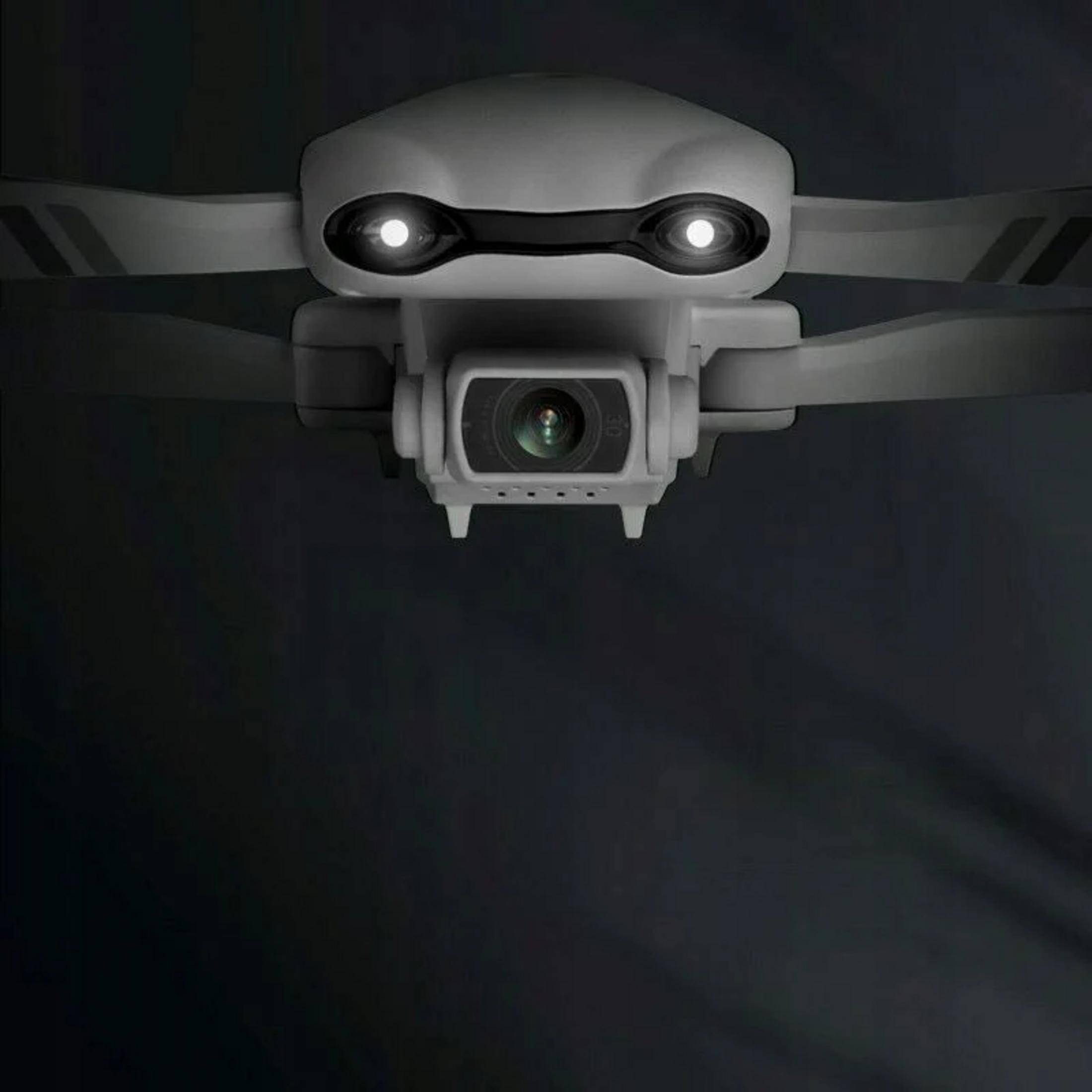 Biały dron ze świecącymi oczami i kamerą na ciemnym tle.