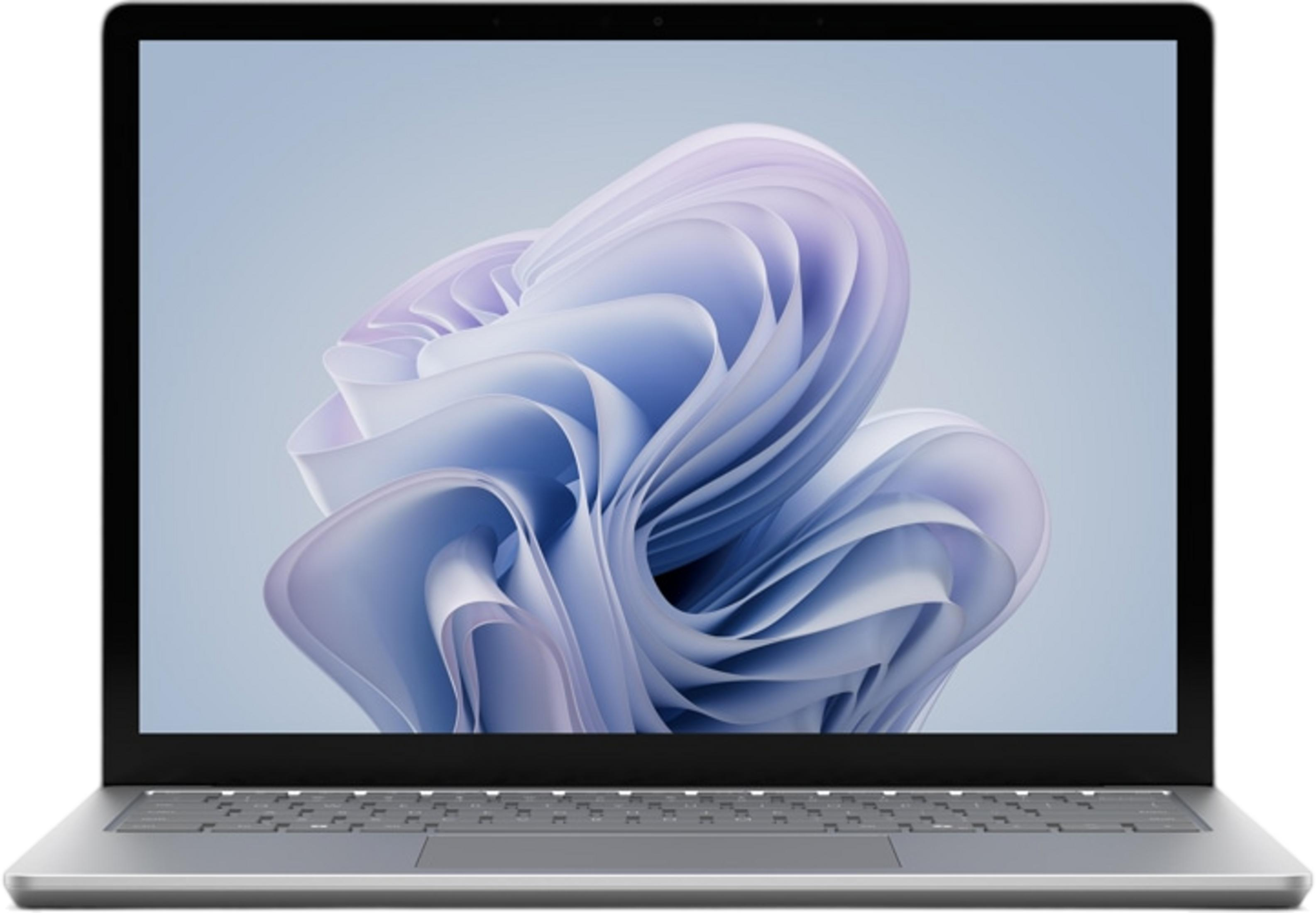 Ein silberner Laptop zeigt ein abstraktes, wellenförmiges Desktop-Hintergrundbild in Blau- und Lilatönen.