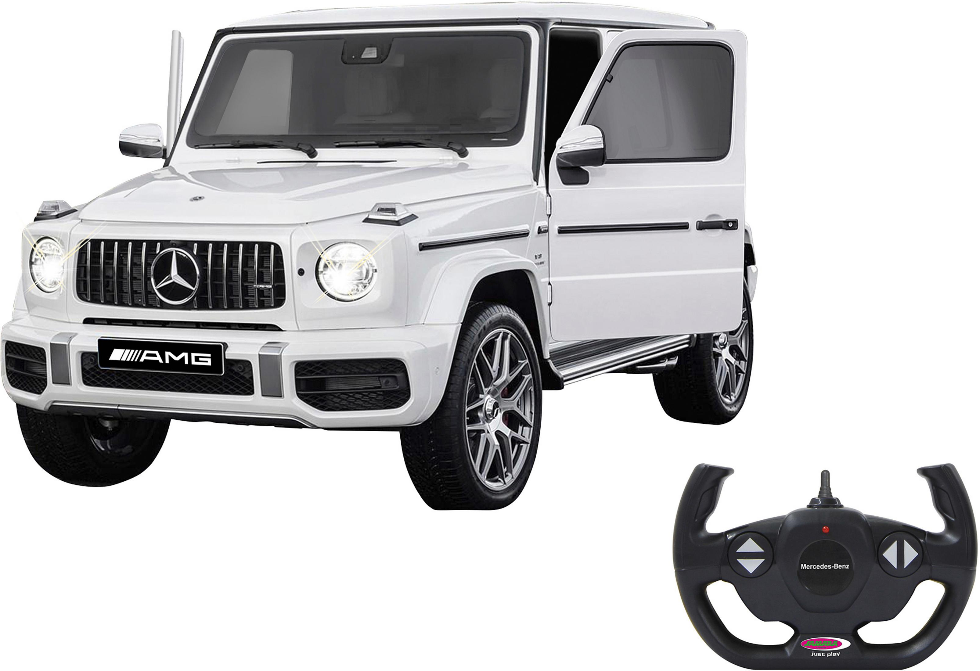 Ein weißer Mercedes G-Wagen mit offener Tür und Fernbedienung.