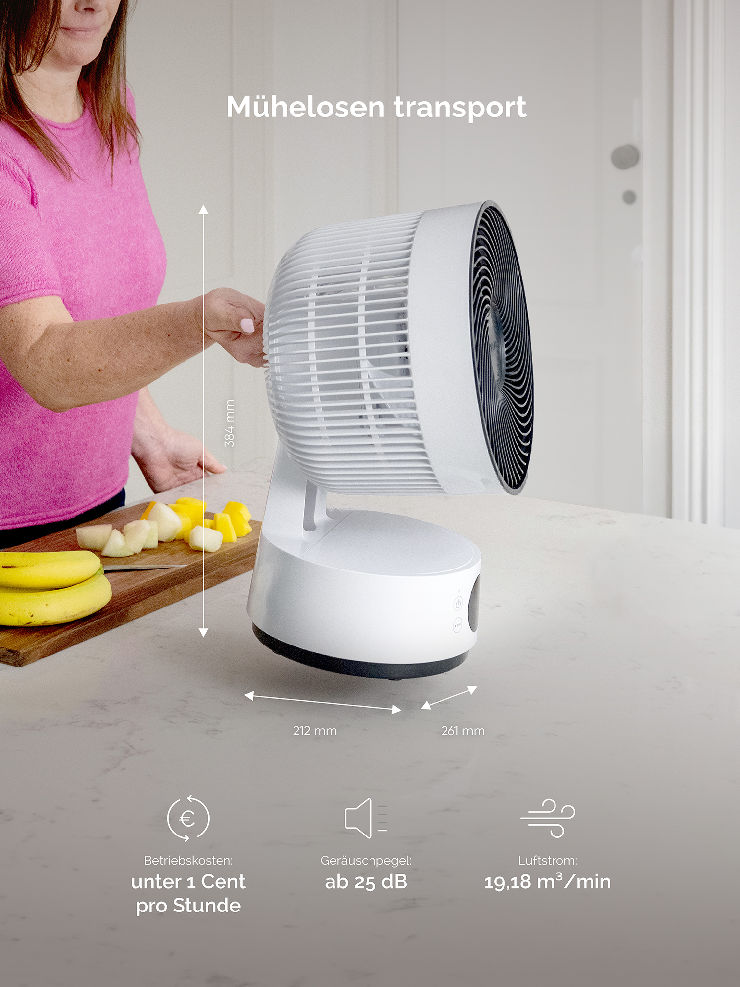 Ventilador blanco en encimera de cocina junto a fruta. Dimensiones: A 384mm, An 212mm, Pr 261mm.