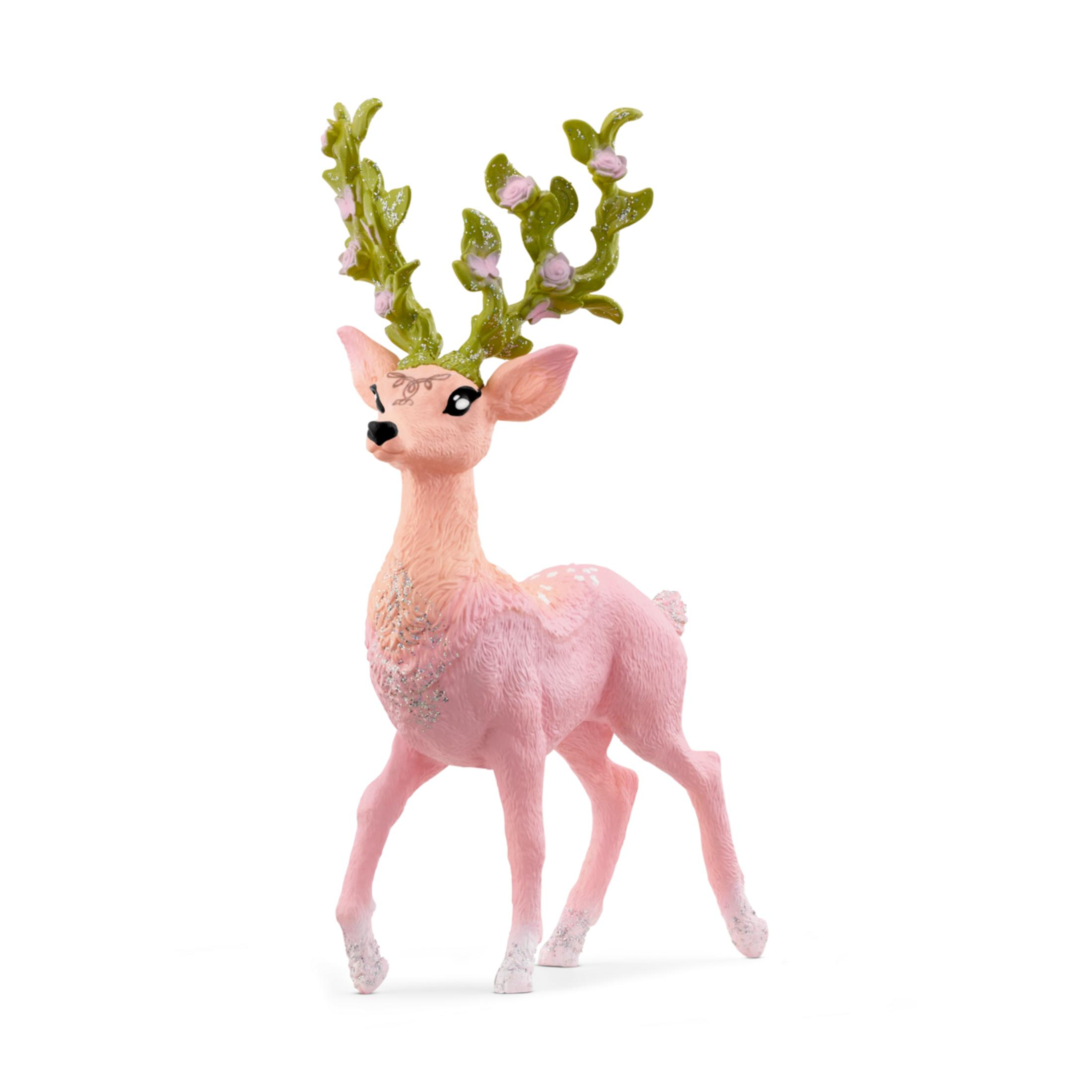 Una figurina di cervo rosa con corna verdi adornate con piccoli fiori rosa.