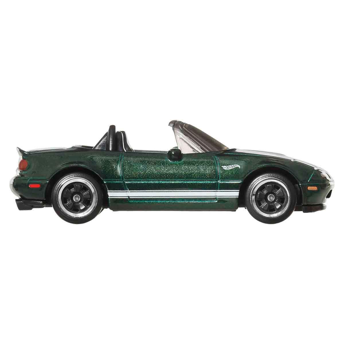 Roadster cabriolet verde scuro con strisce bianche, capote aperta e ruote nere.