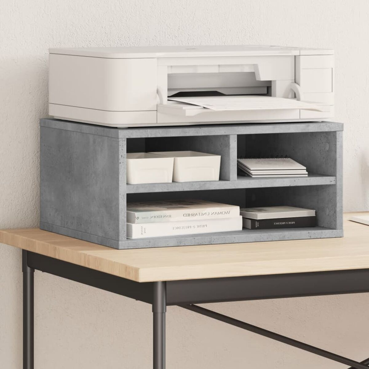 Ein weißer Drucker steht auf einem grauen Schreibtisch-Organizer mit Büchern und Behältern.