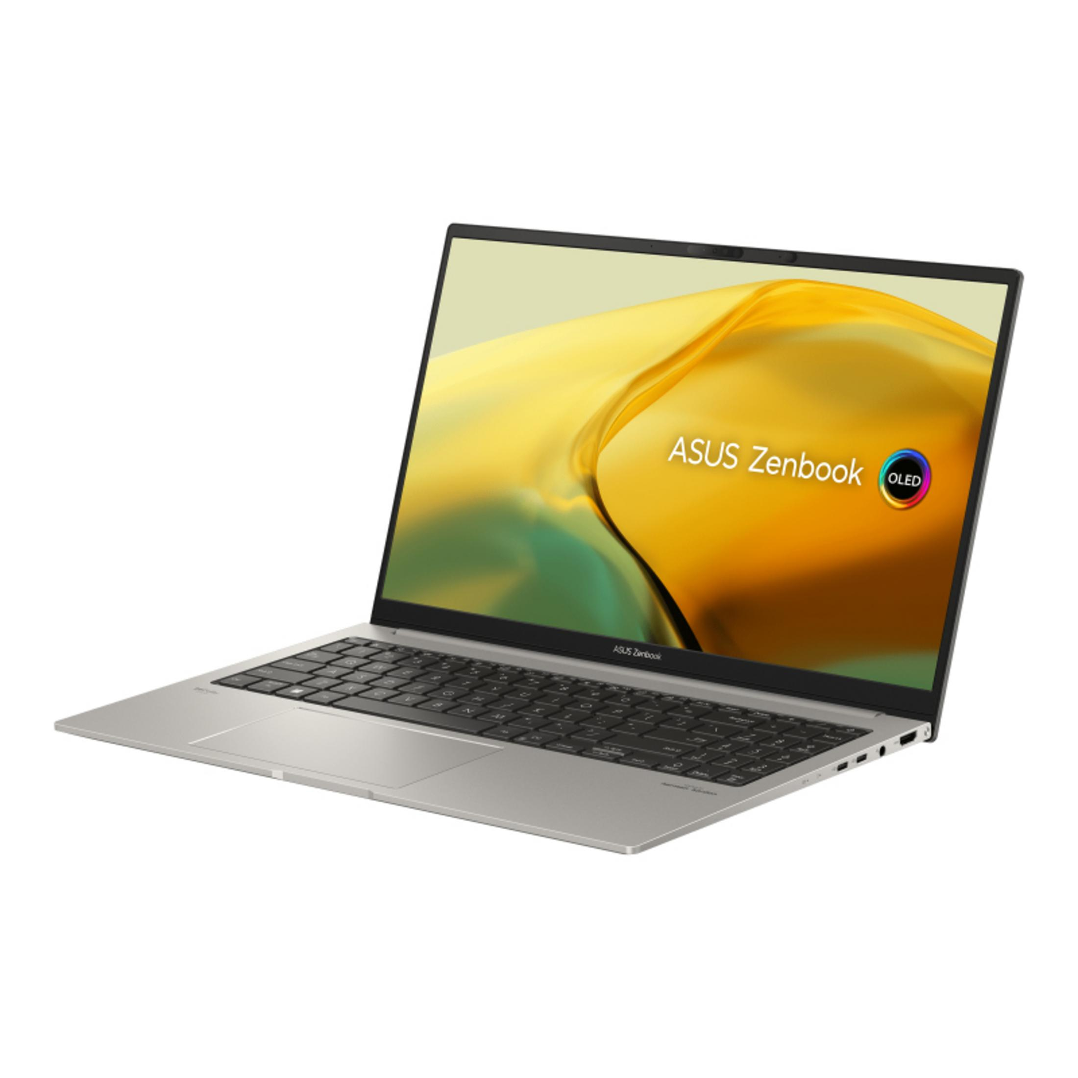 Un portátil ASUS Zenbook plateado con pantalla OLED está abierto sobre fondo blanco.