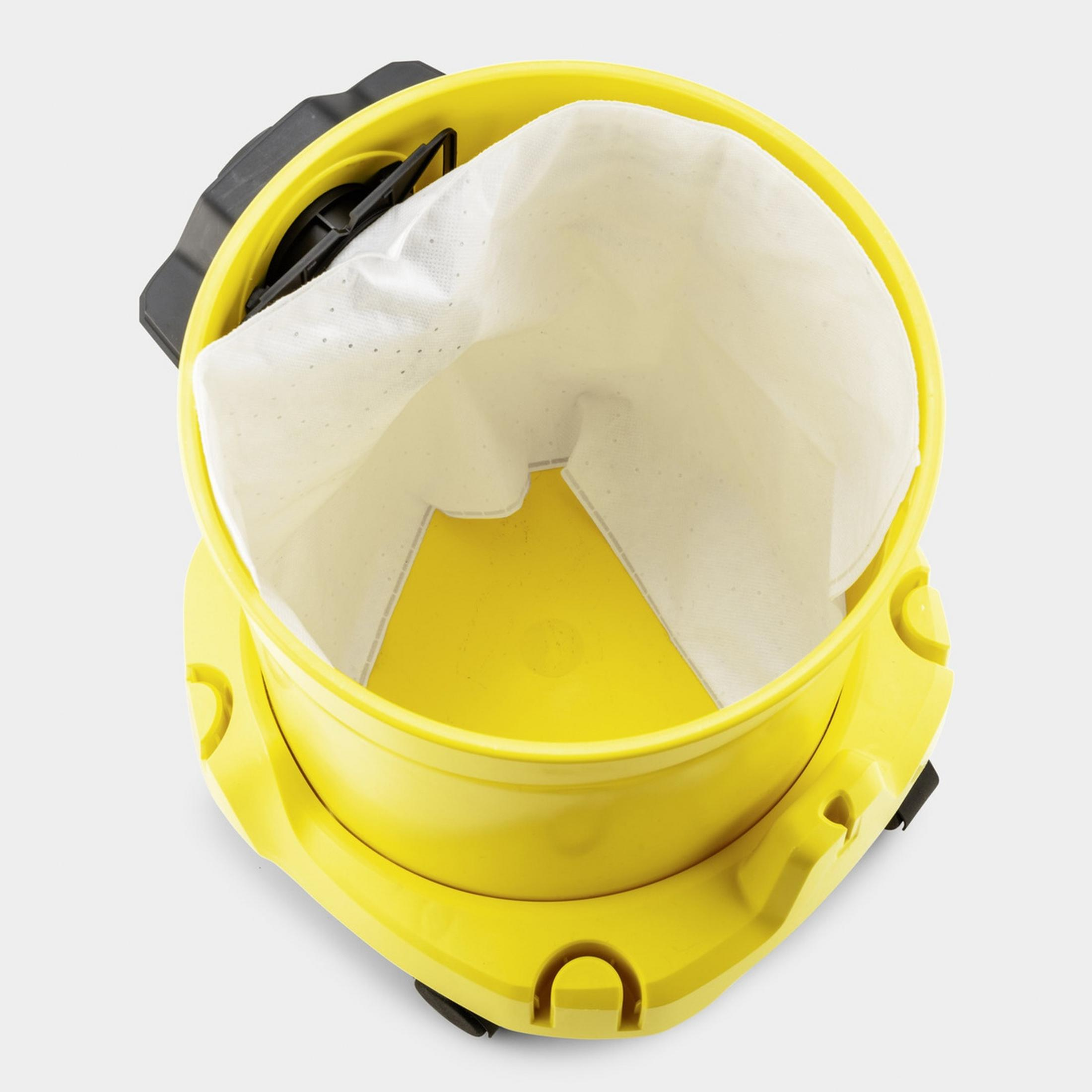 Contenedor de aspiradora amarillo con una bolsa de polvo blanca dentro.