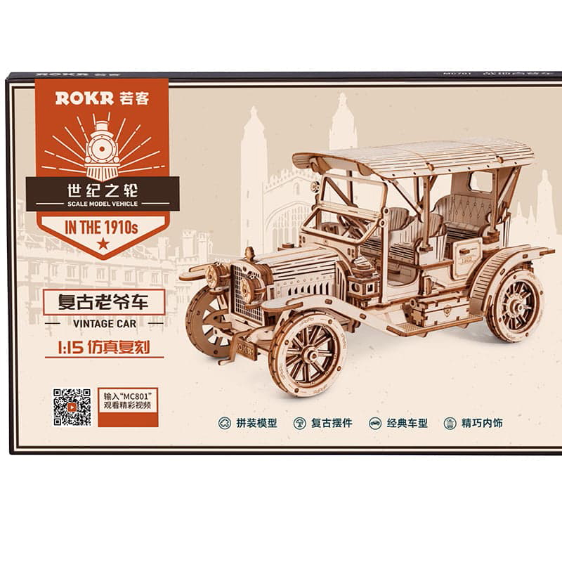 Ein Holzmodell eines Oldtimers im Stil der 1910er Jahre auf einer Kartonverpackung.