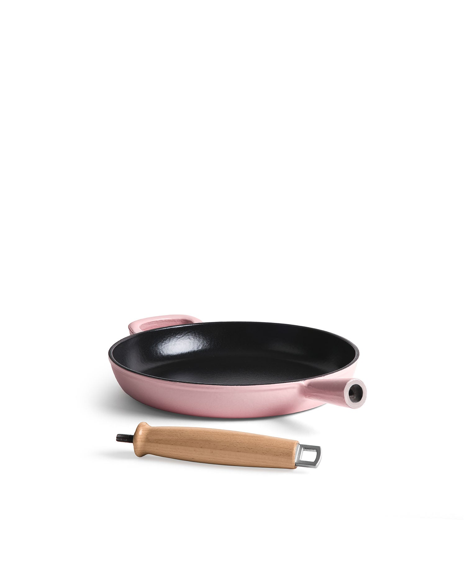 Una sartén de hierro fundido rosa con interior negro y un mango de madera al lado.