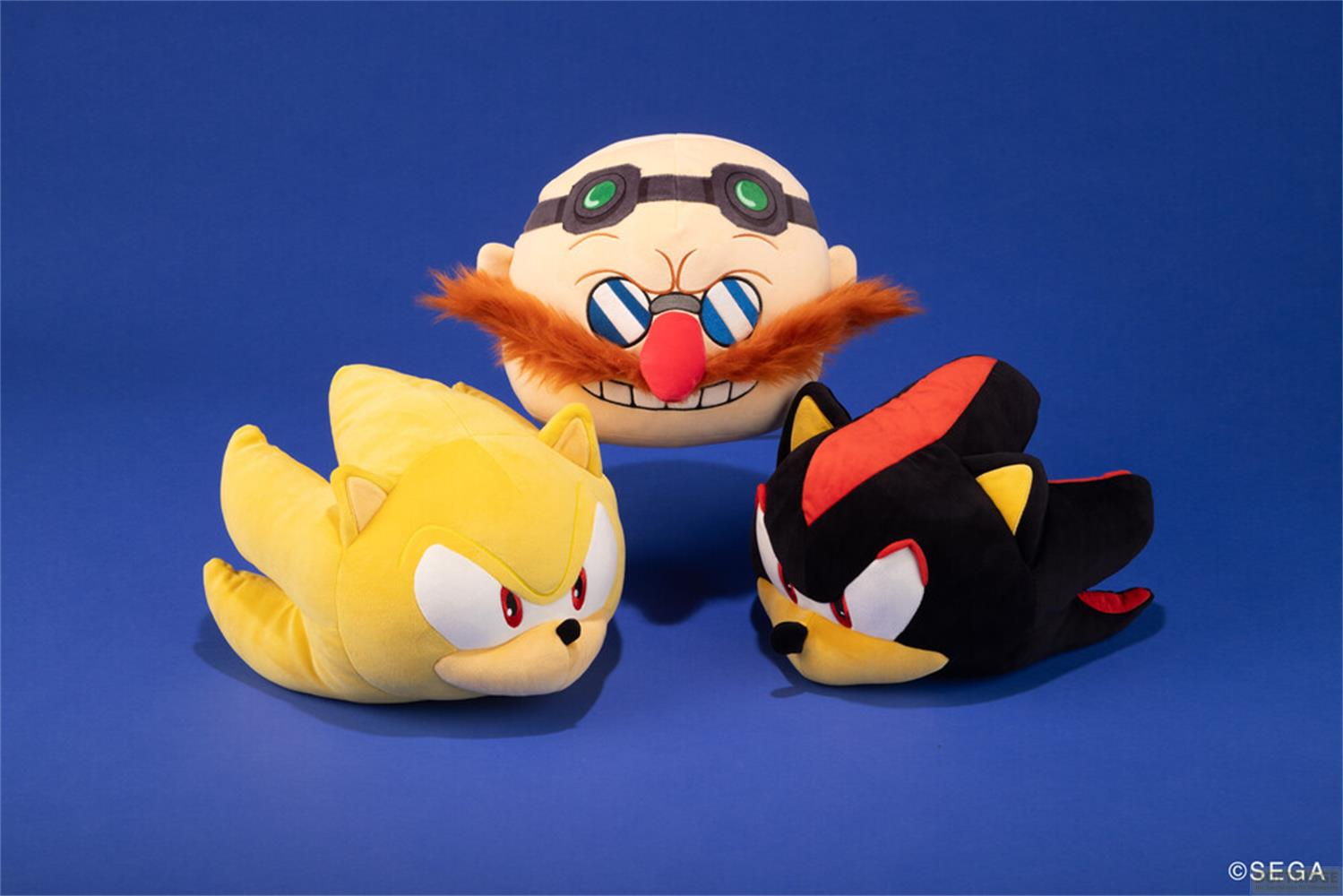 Peluche di Dr. Eggman, Super Sonic e Shadow su sfondo blu.