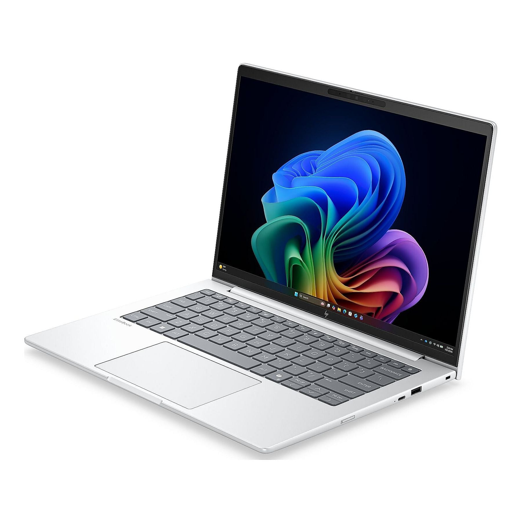 Un laptop argento con uno sfondo colorato sul desktop. La tastiera è visibile.