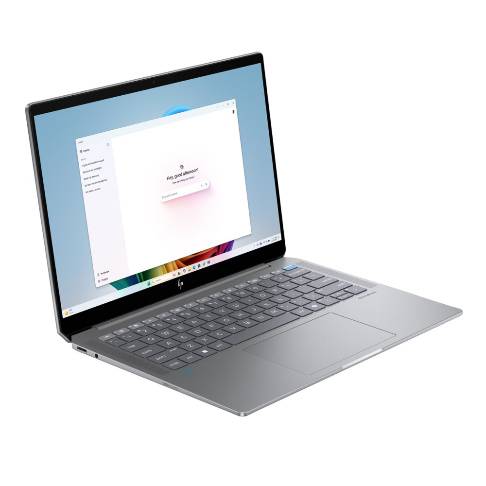 Srebrny laptop z jasnym ekranem wyświetlającym powitalną wiadomość.