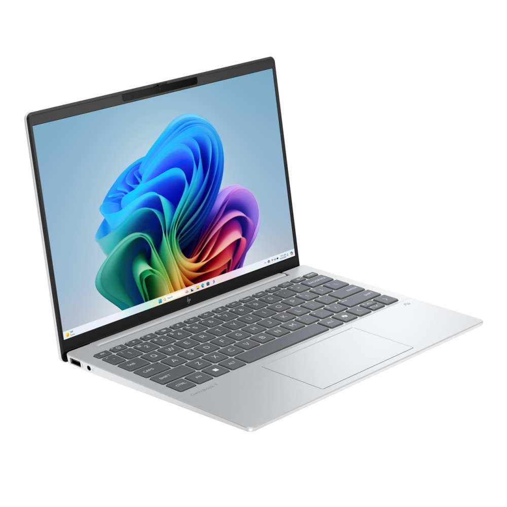Srebrny laptop z kolorową tapetą na ekranie.