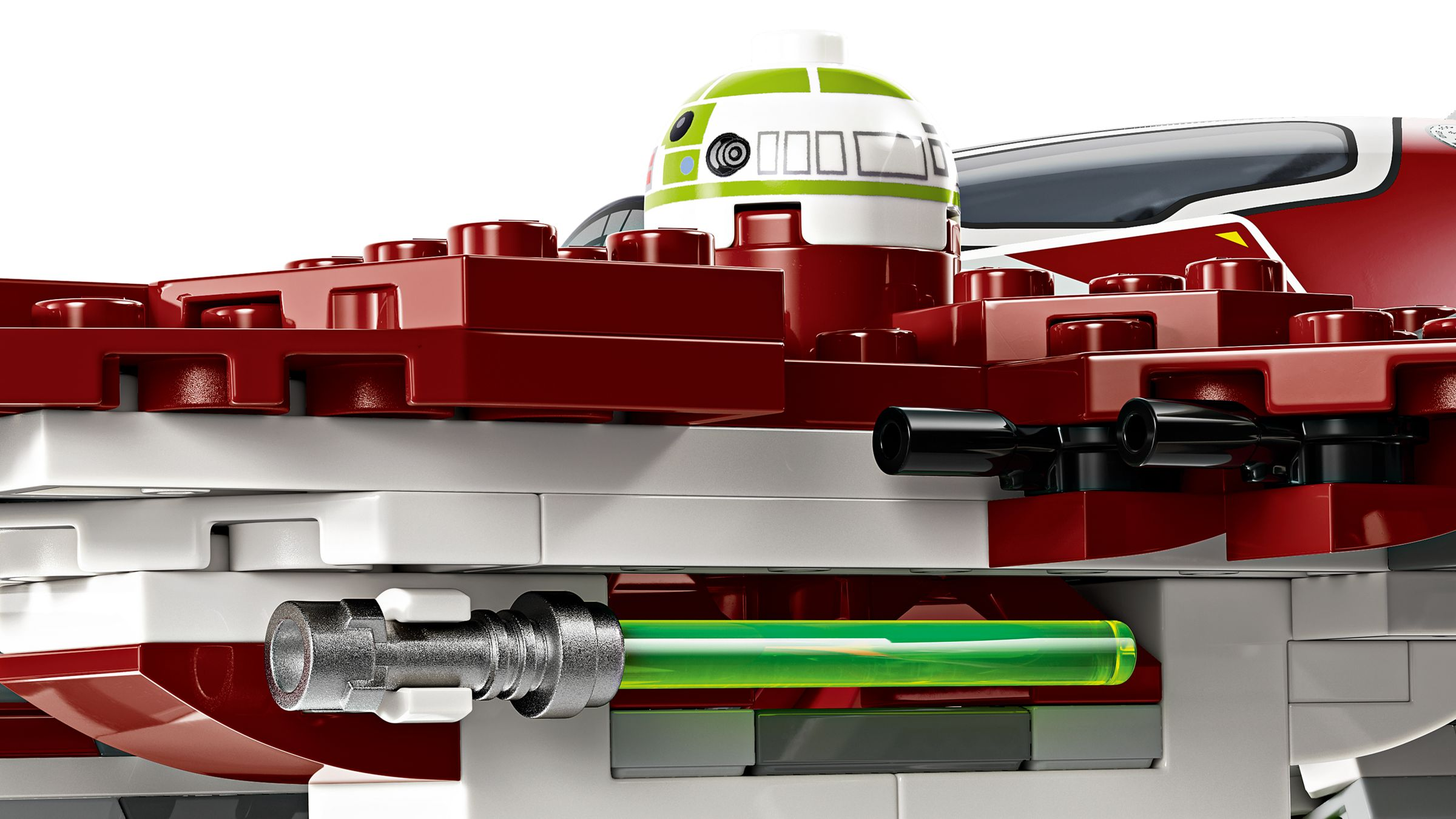 Ein grüner Lichtstab steckt in einem silbernen Griff, umgeben von roten und weißen Legosteinen.