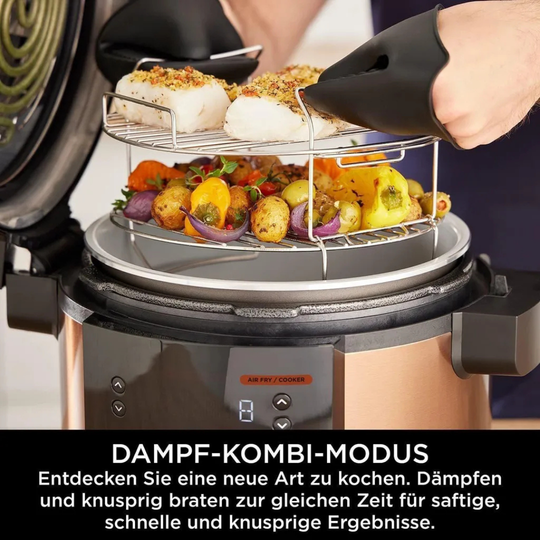 Ein Dampfgarer mit zwei Ebenen, beladen mit Fisch und Gemüse, wird herausgenommen.