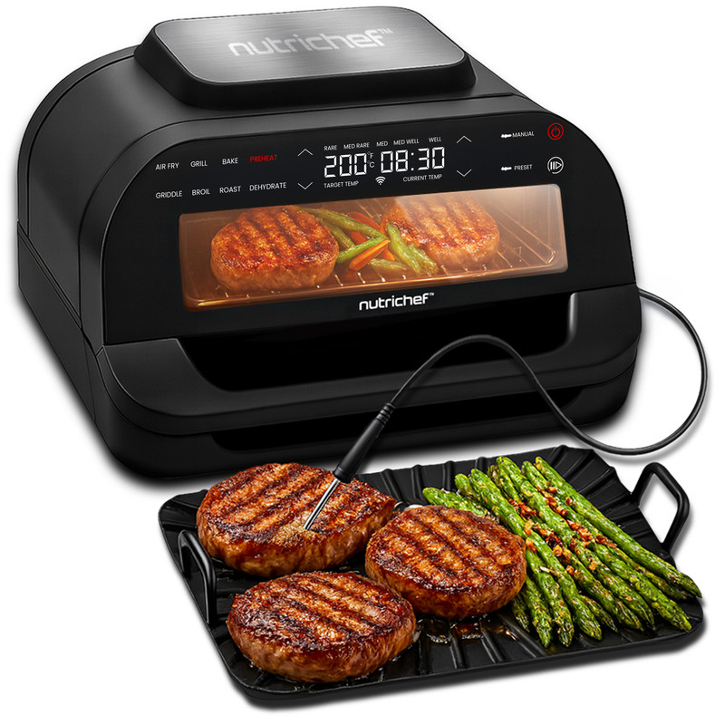 Una griglia Nutrichef cuoce hamburger e asparagi. Un termometro in un hamburger.
