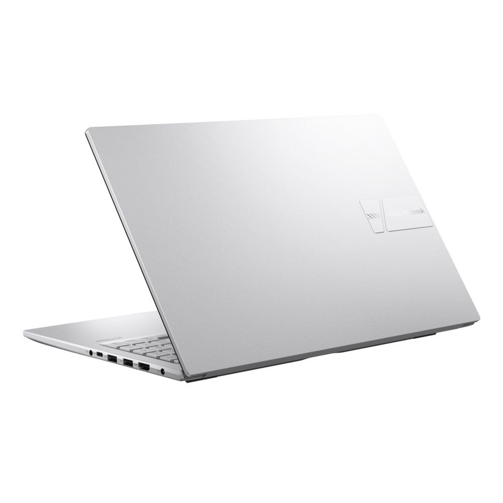 Srebrny laptop jest otwarty, widać klawiaturę i porty.