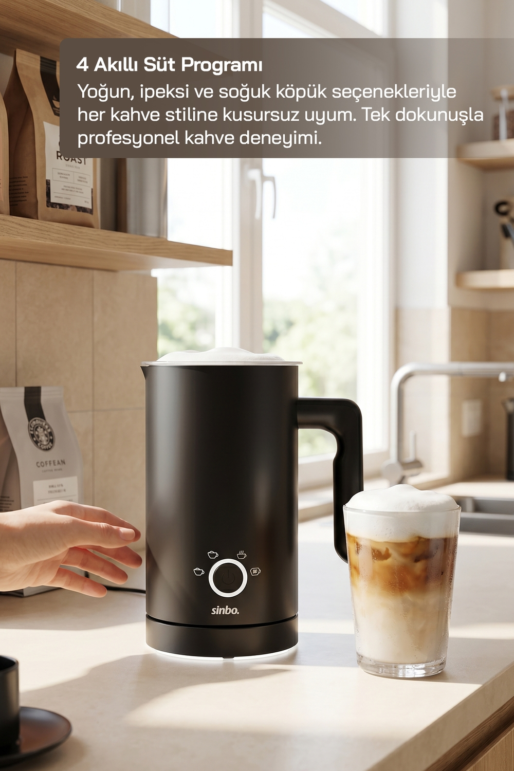 Siyah süt köpürtücü, buzlu kahve bardağının yanında. Rafta kahve paketleri.