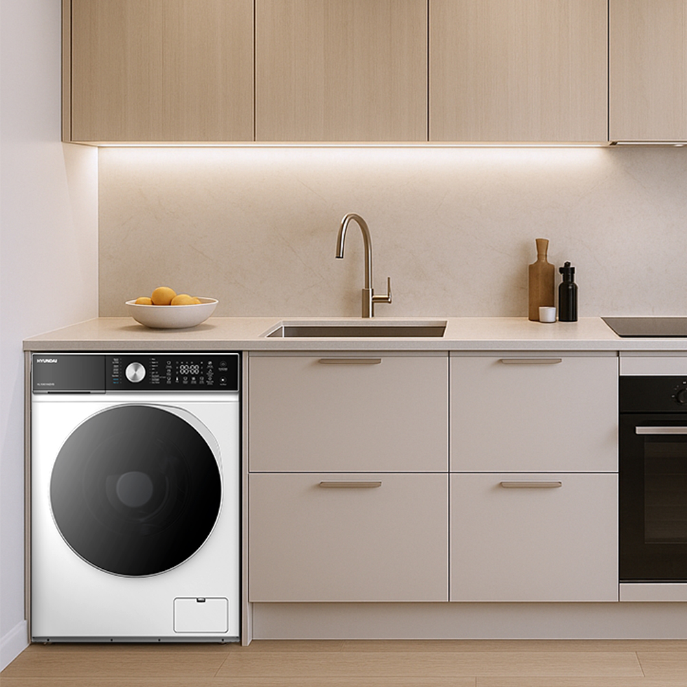 Cocina moderna con lavadora, fregadero, estufa y gabinetes.