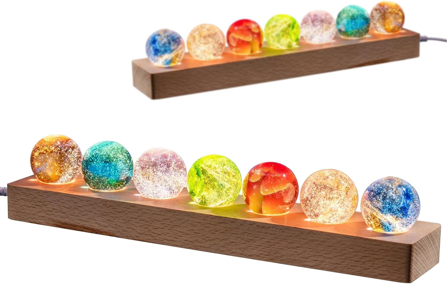 Acht bunte, glitzernde Glaskugeln auf Holzsockel, von unten beleuchtet.