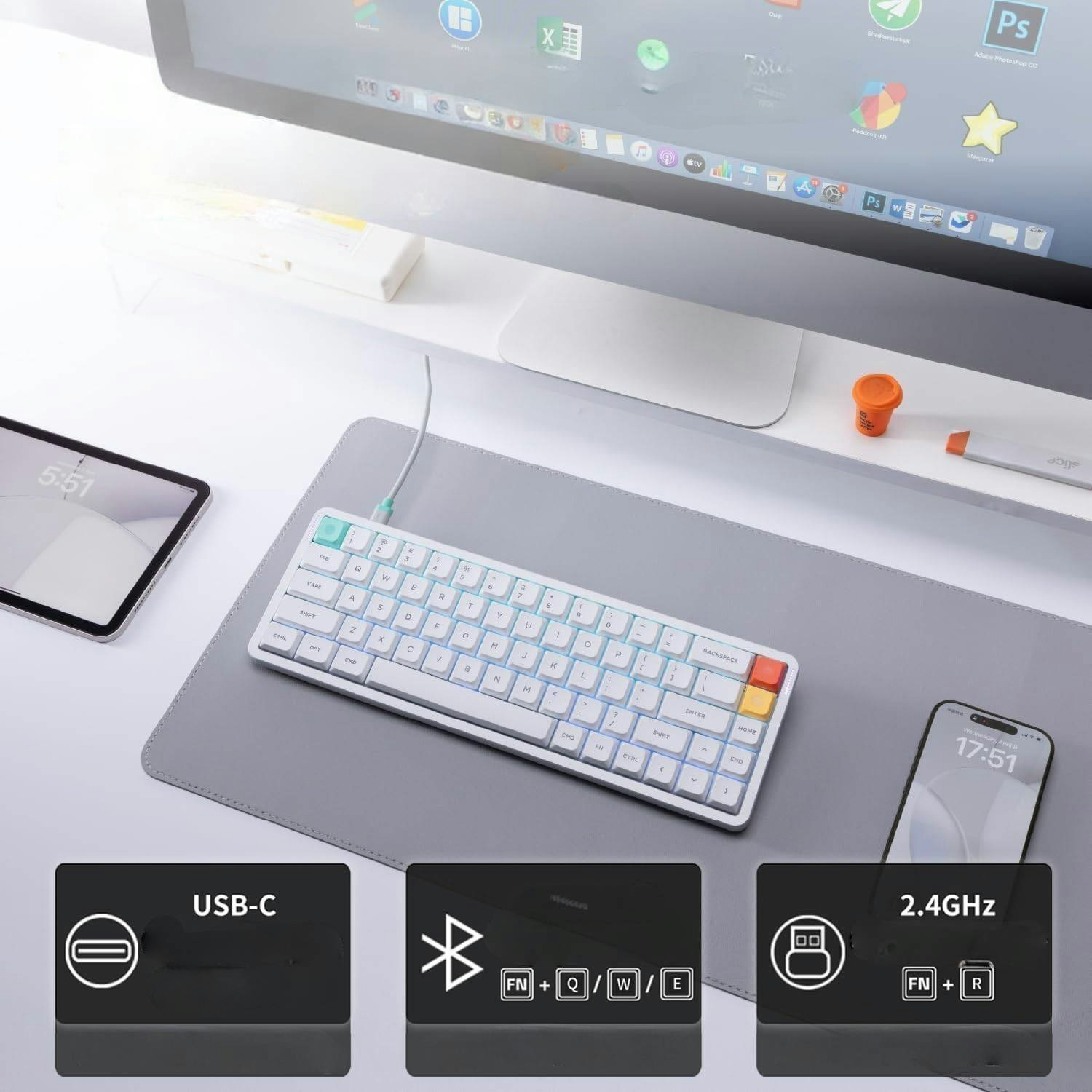Biała klawiatura z podświetleniem RGB, tablet i telefon na biurku.