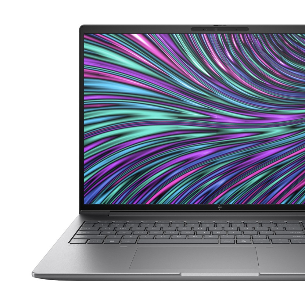 Zamknięty laptop wyświetlający kolorowy, abstrakcyjny wzór na ekranie i klawiaturze.