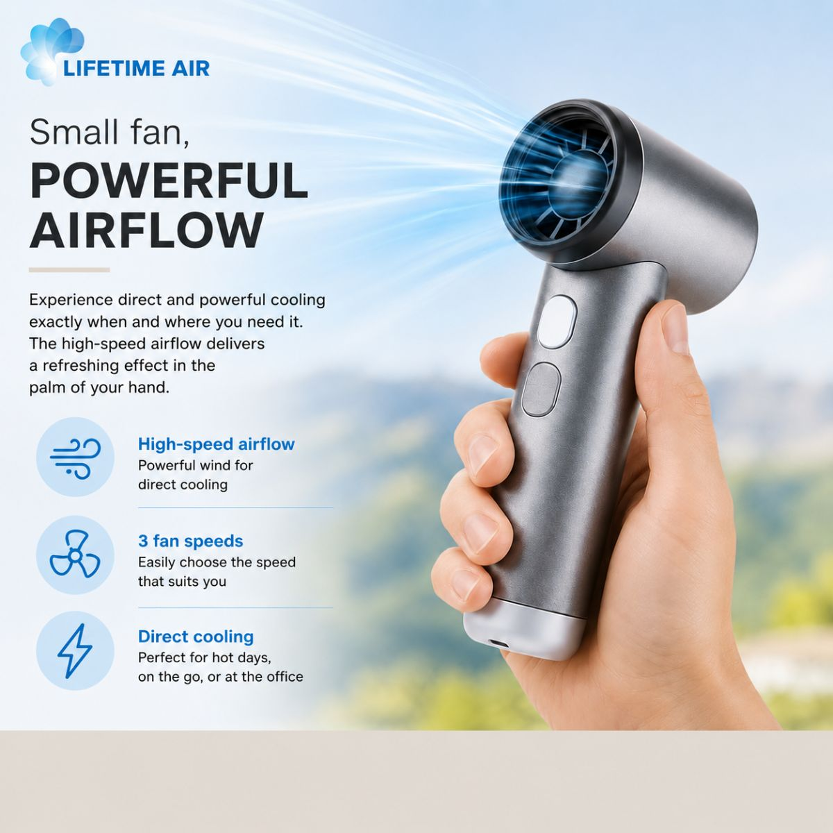 Un ventilatore portatile grigio con potente flusso d'aria è tenuto da una mano.