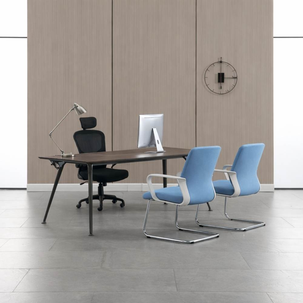 Ufficio moderno con scrivania in legno scuro, sedia nera, computer, lampada e due sedie blu.