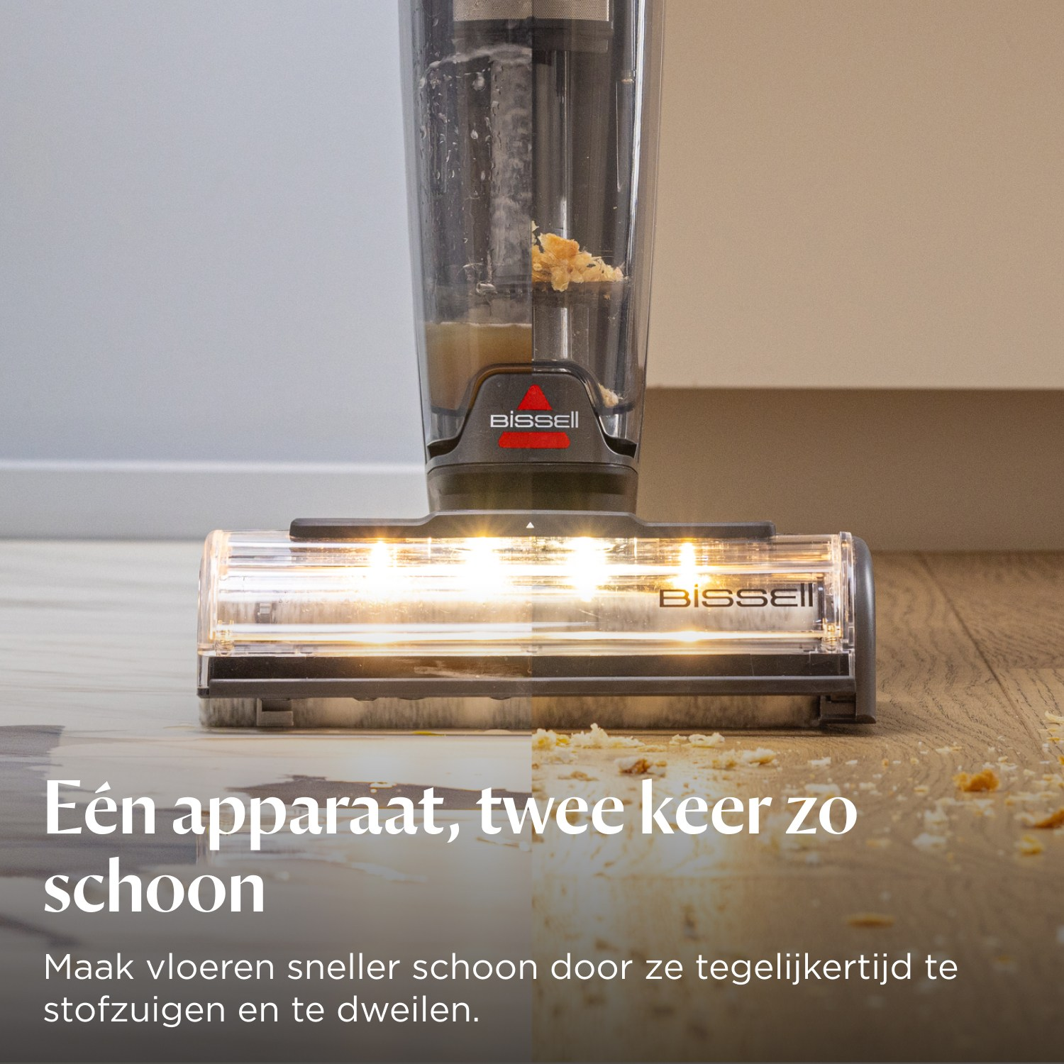 Bissell nat-/droogzuiger reinigt kruimelig houten vloer met vloeistof.