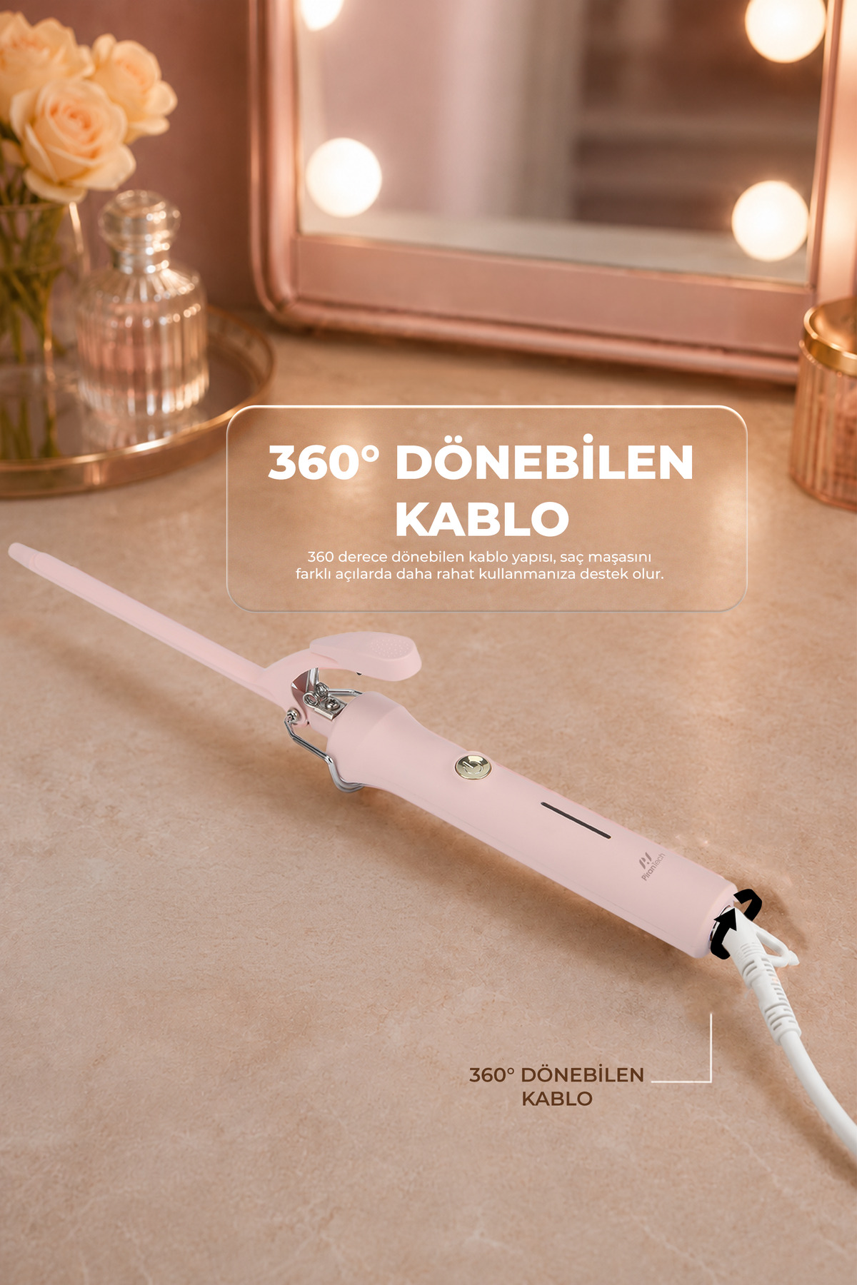 Pembe bir saç maşası, 360 derece dönebilen kablolu, çiçekler ve makyaj aynasıyla.