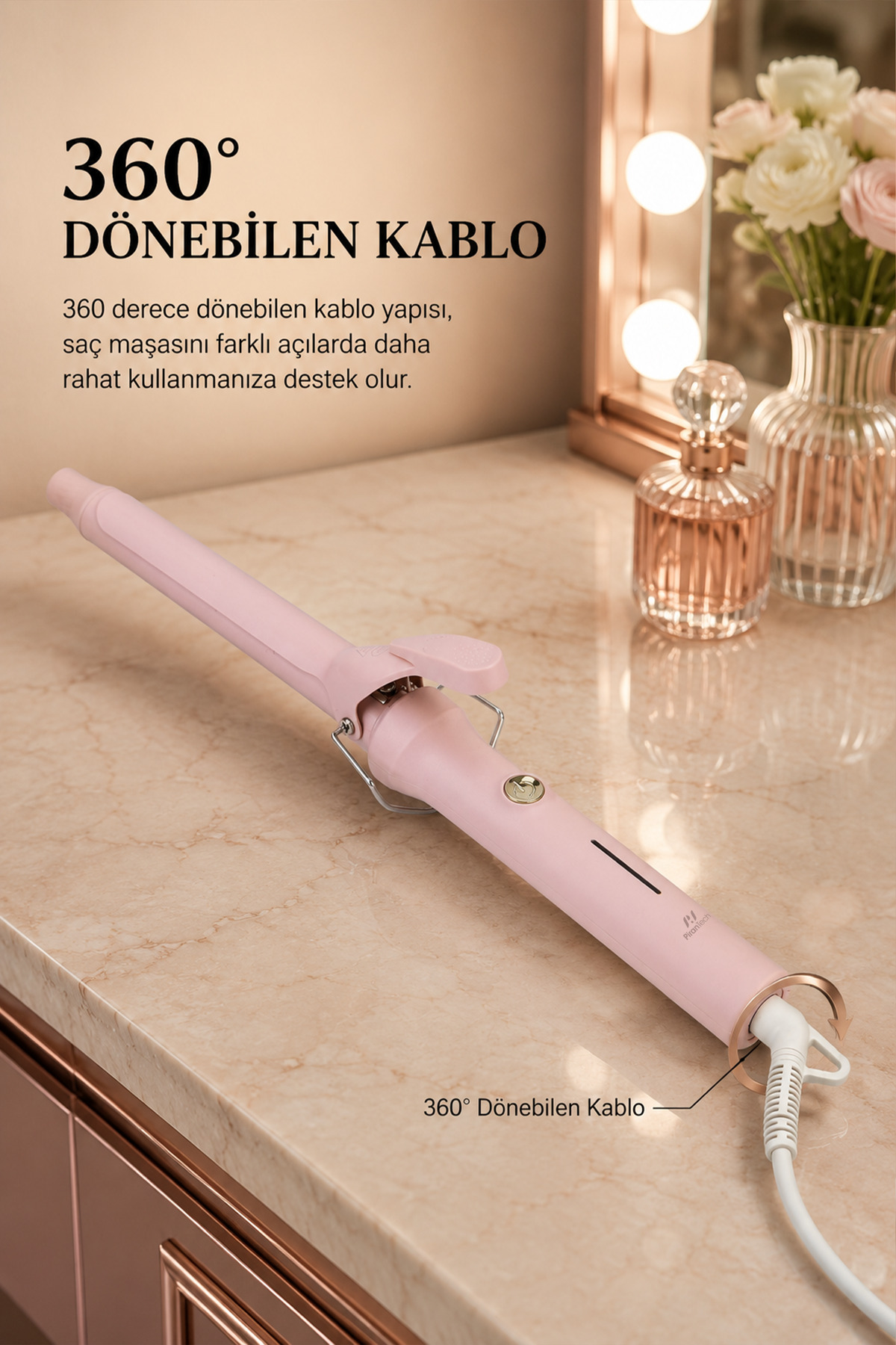 Mermer yüzeyde 360° dönebilen kablolu pembe saç maşası.