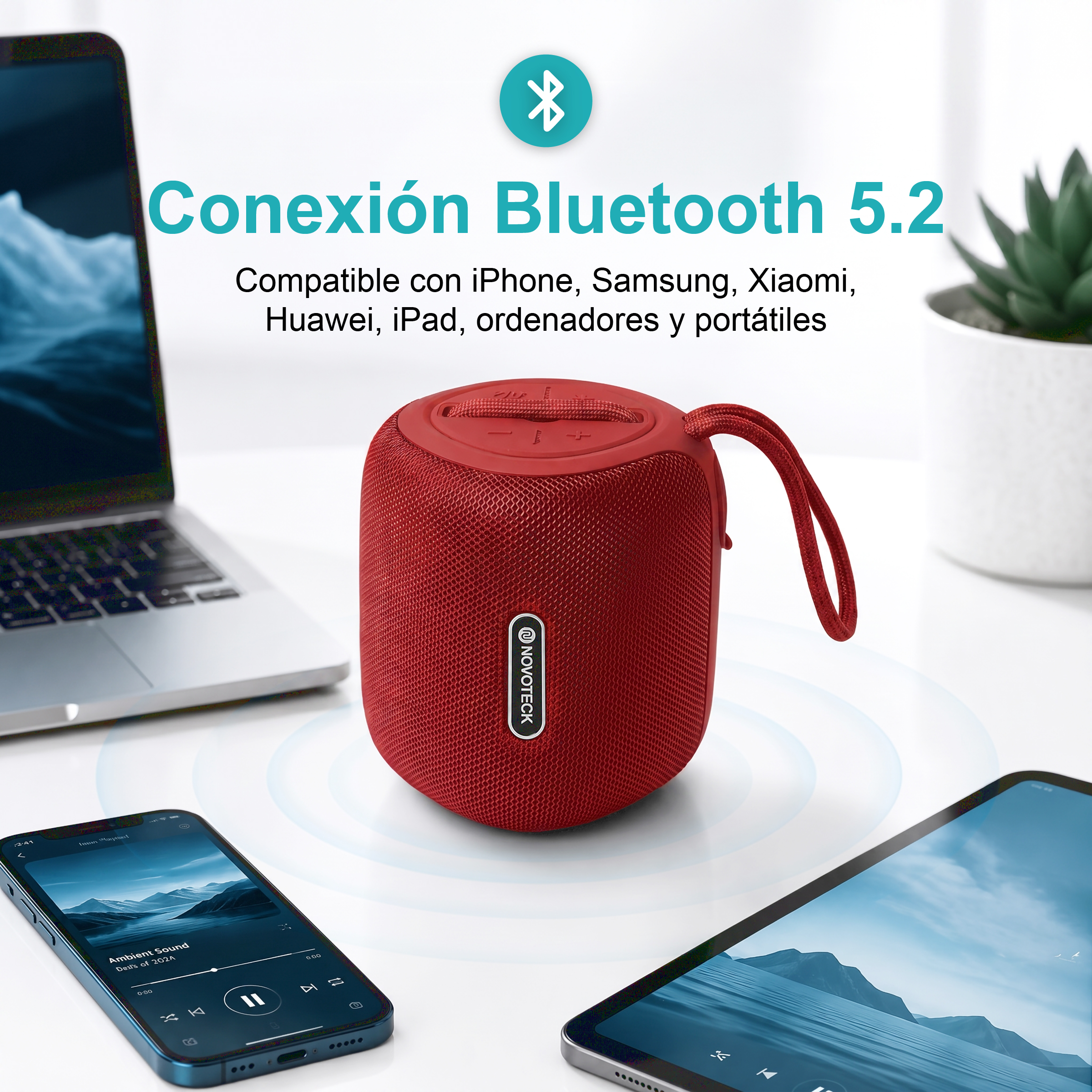 Uno speaker Bluetooth rosso tra un laptop, smartphone e tablet.