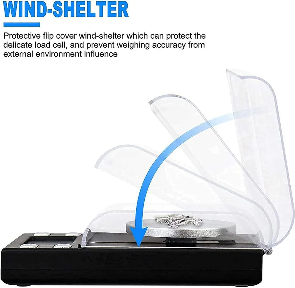 Eine schwarze Digitalwaage mit einem durchsichtigen Klappschutz gegen Wind, der Schmuck schützt.