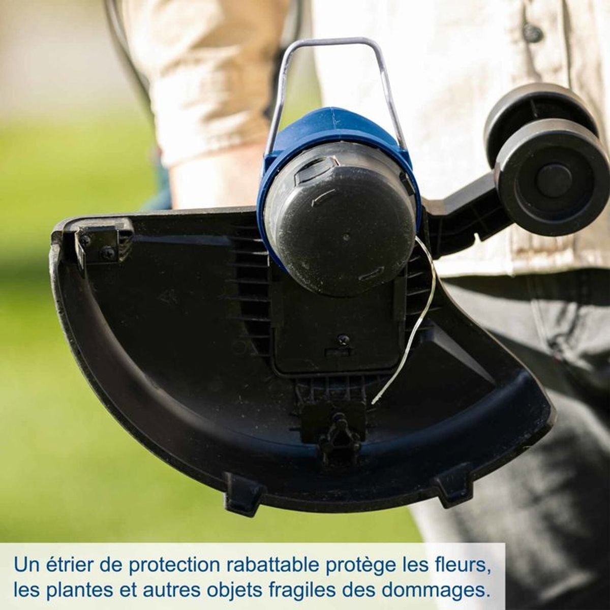 A person holds a grass trimmer with a blue motor and black shield.