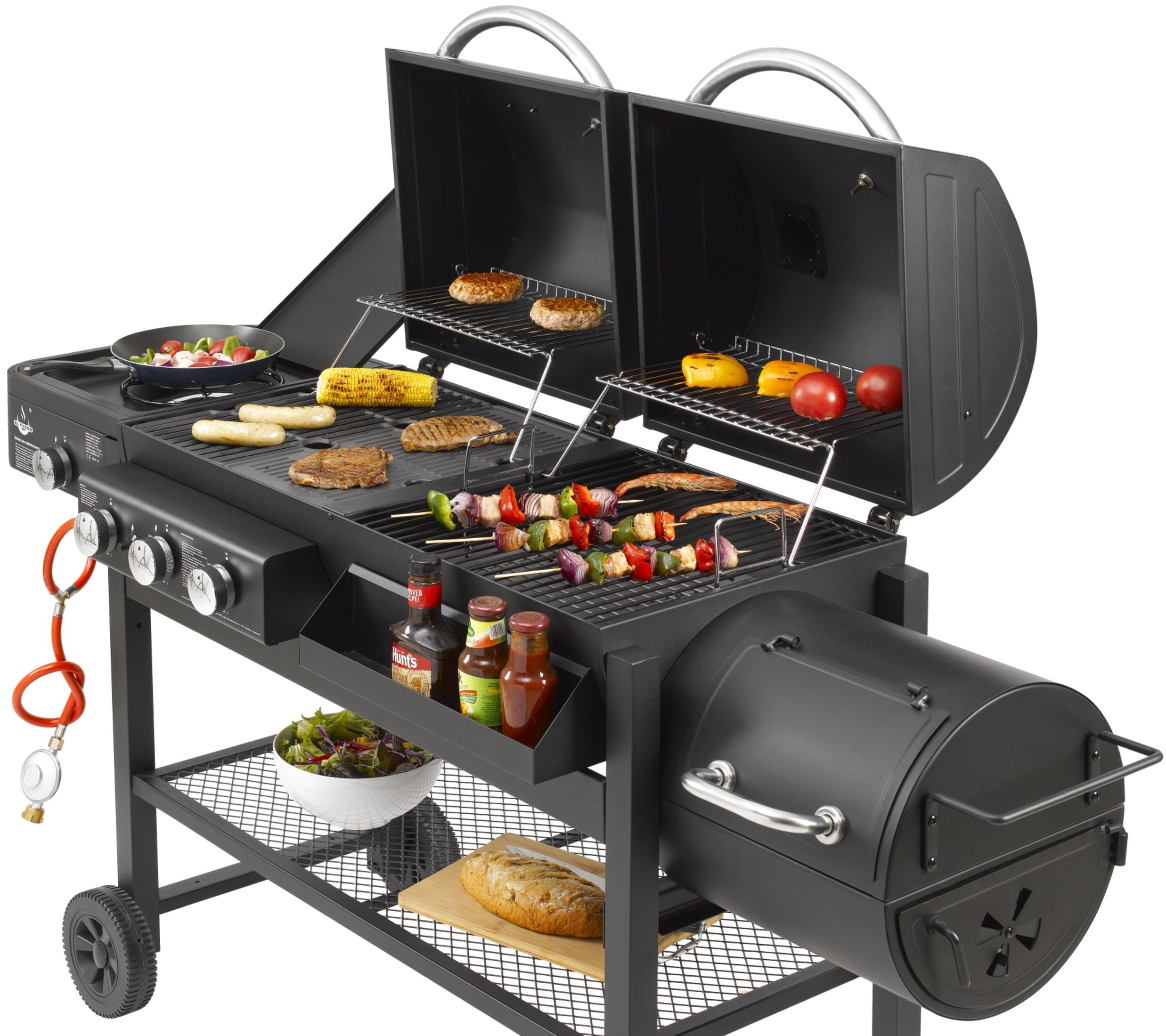 Ein schwarzer Grill mit offenem Deckel, auf dem verschiedene Speisen zubereitet werden.