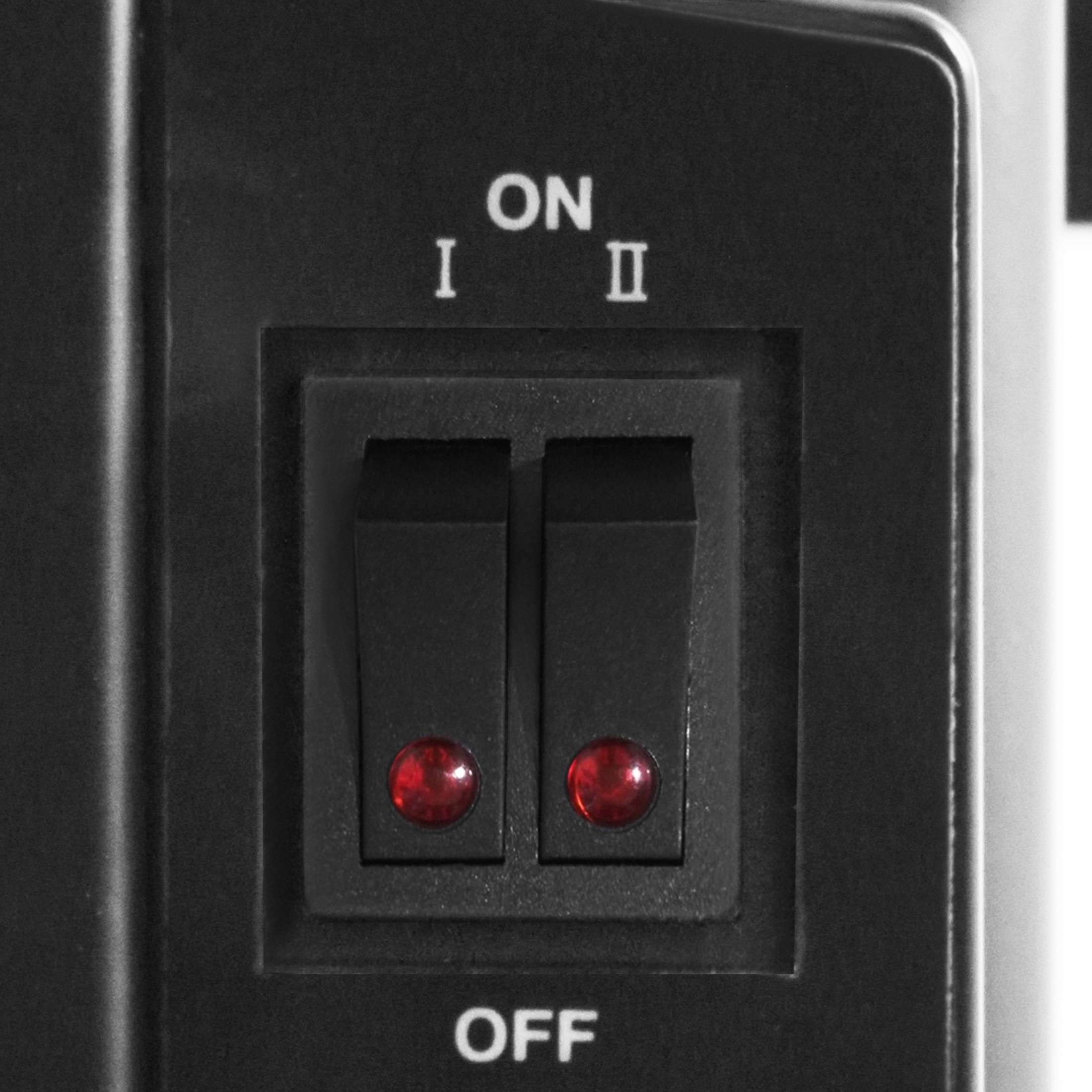 Dos luces rojas se iluminan debajo de dos interruptores basculantes negros en un panel negro.